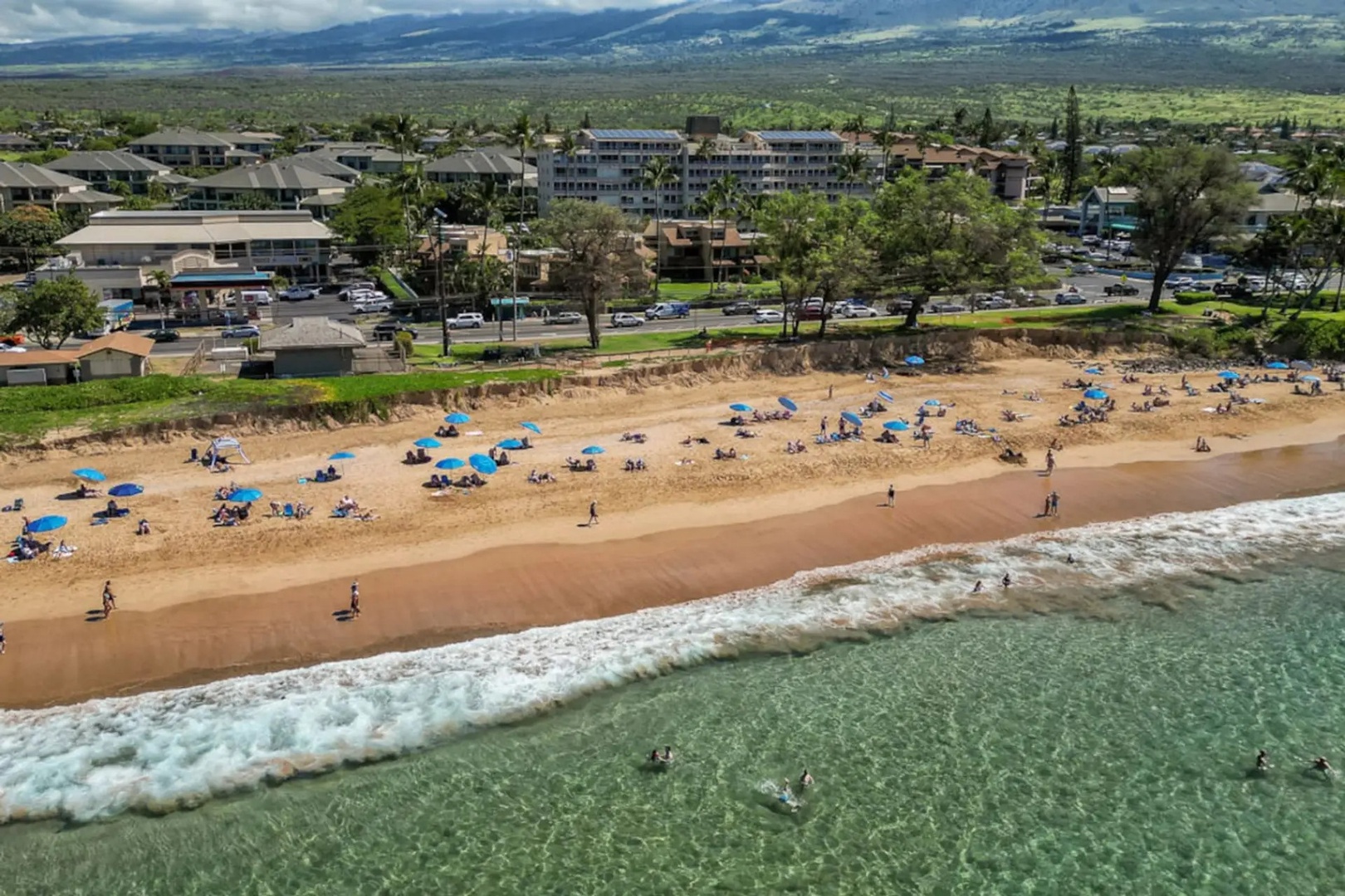 Kihei Vacation Rentals, Kamaole Beach Royal 610 - Blue umbrellas dot the sand.