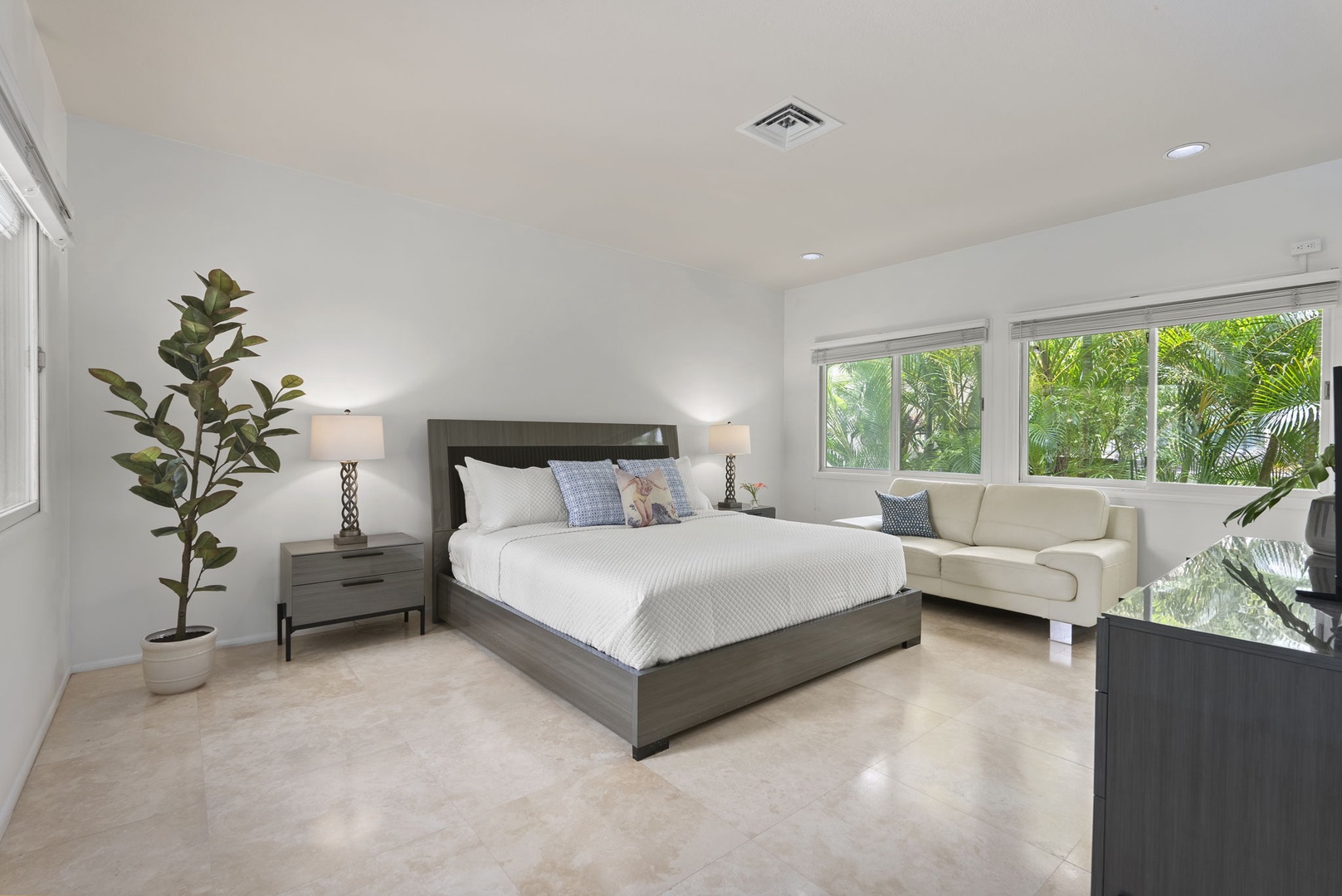 Honolulu Vacation Rentals, Paradise Beach Estate - This sunlit guest bedroom features clean lines, a king-size bed, and garden views—ideal for extended stays.