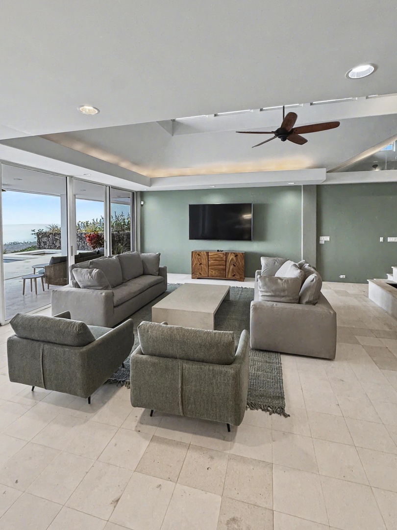 Kailua Kona Vacation Rentals, Hale Nai'a - Sink into plush seating while enjoying panoramic views through floor-to-ceiling windows in your sophisticated living space.