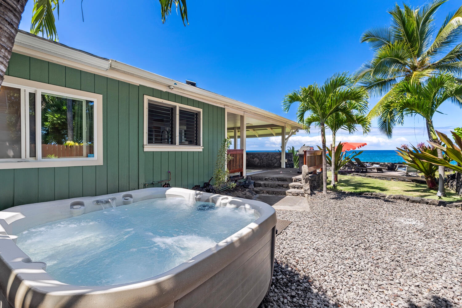 Kailua Kona Vacation Rentals, Honl's Beach Hale (Big Island) - Backyard hot tub for a soothing soak beneath swaying palms.