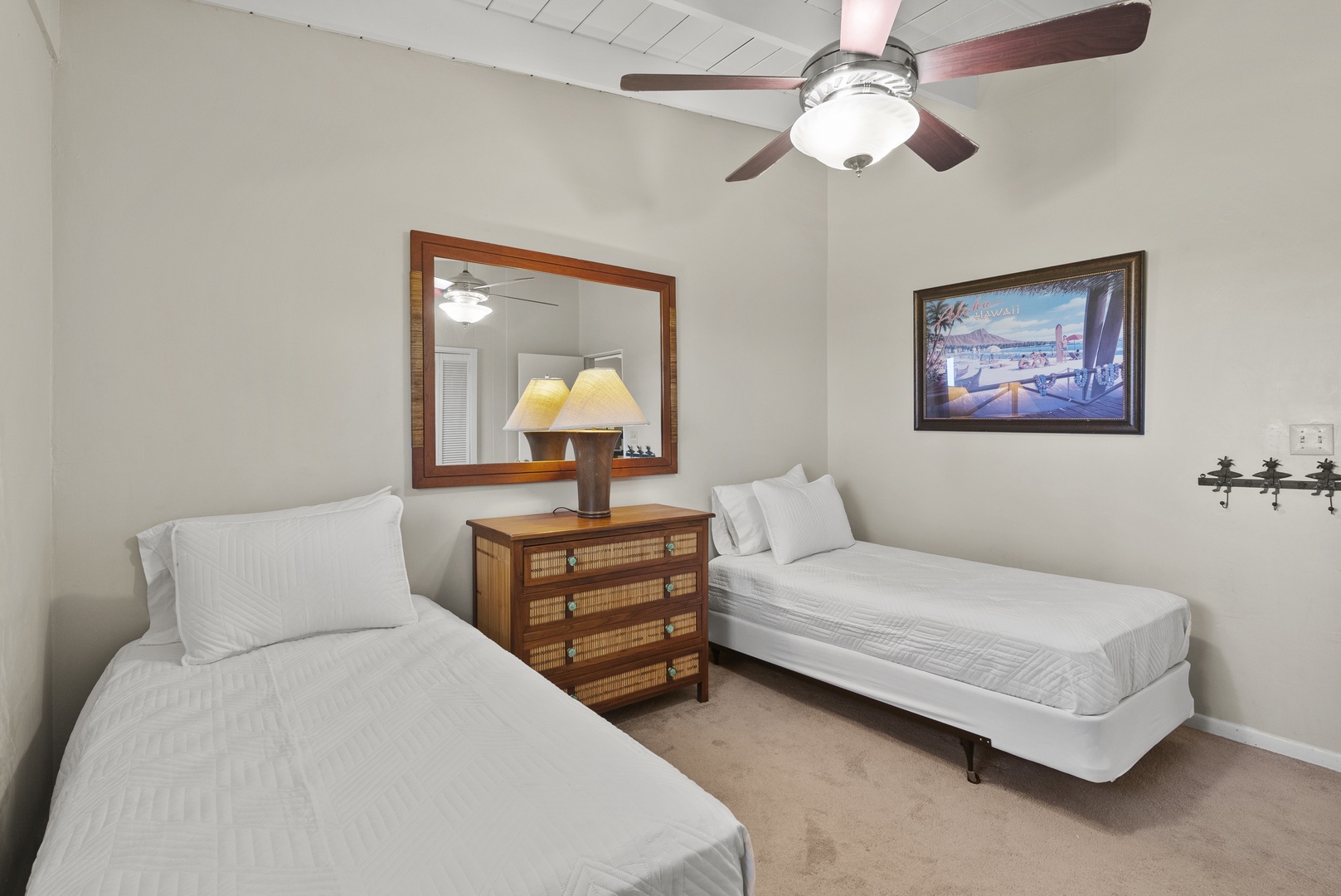 Haleiwa Vacation Rentals, North Shore Beachfront Retreat - Bright twin bedroom with two beds and cheerful decor.