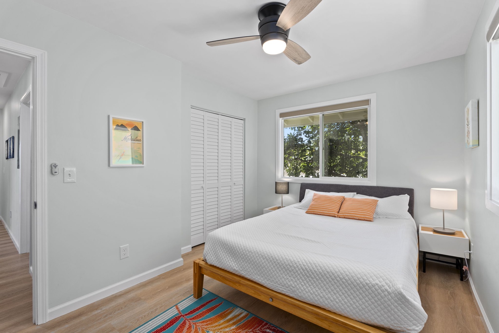 Kailua Vacation Rentals, Hale Alapi'i Lanikai Getaway - Relax in this bright and welcoming bedroom, featuring a playful tropical rug that adds warmth to the minimalist decor.