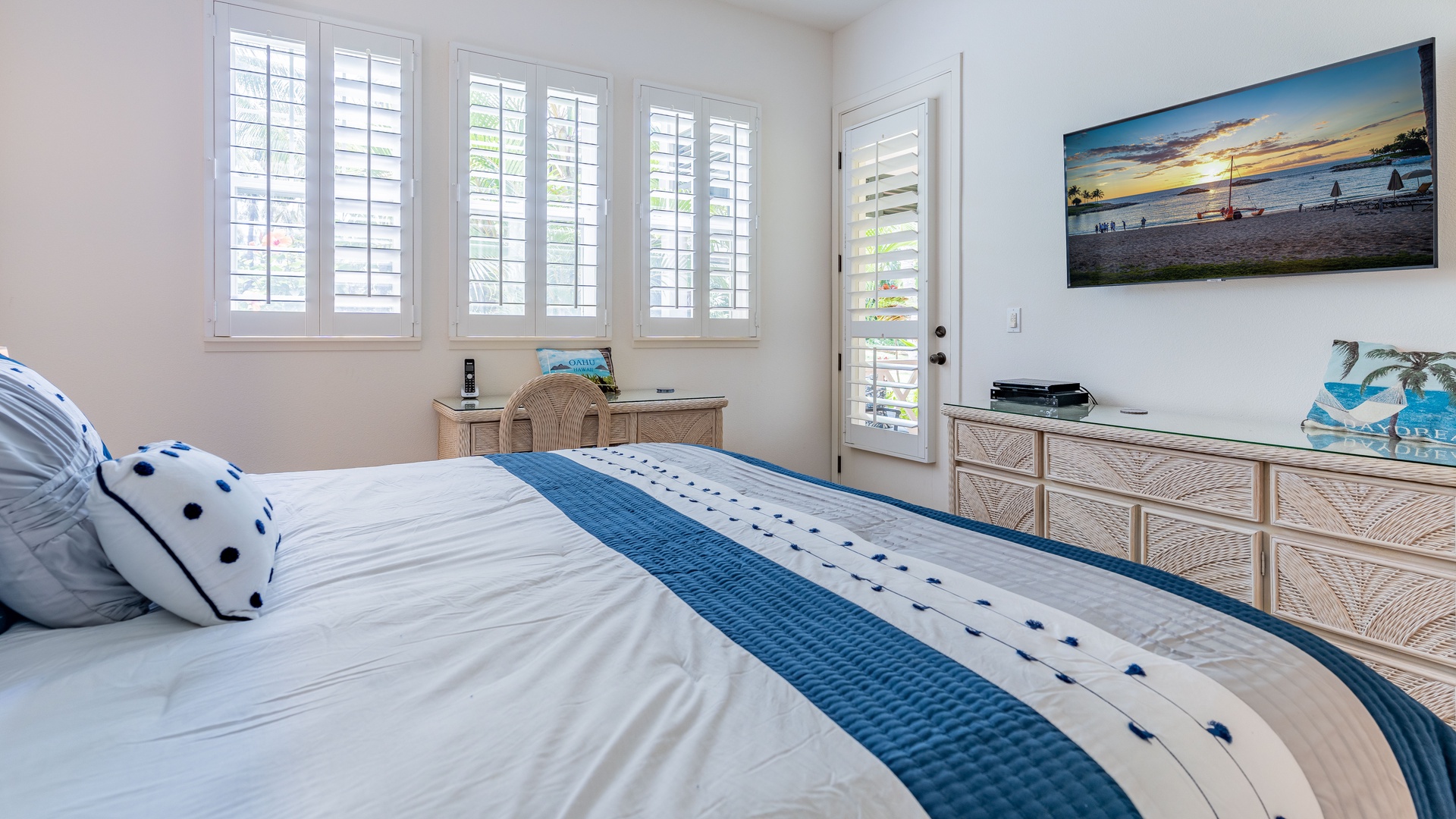 Kapolei Vacation Rentals, Coconut Plantation 1208-2 - The primary guest bedroom with lanai access and a TV.