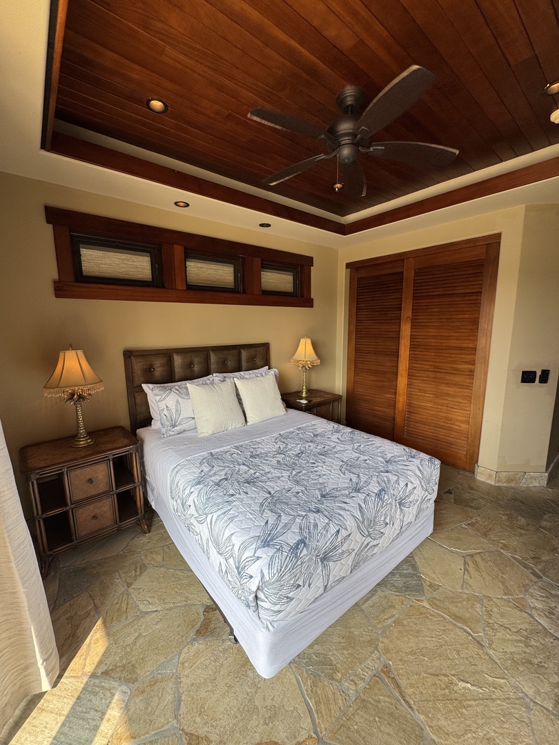 Kamuela Vacation Rentals, Hale Konane - Cozy queen suite with warm lighting, wooden accents, and a serene atmosphere.