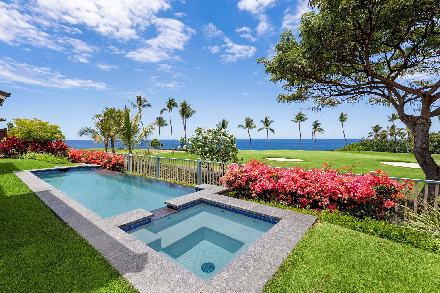 Kailua-Kona Vacation Rentals, Holua Kai #26 - This stunning backyard oasis features a sparkling pool and hot tub, framed by lush tropical landscaping and a breathtaking view of the oceanfront golf course.