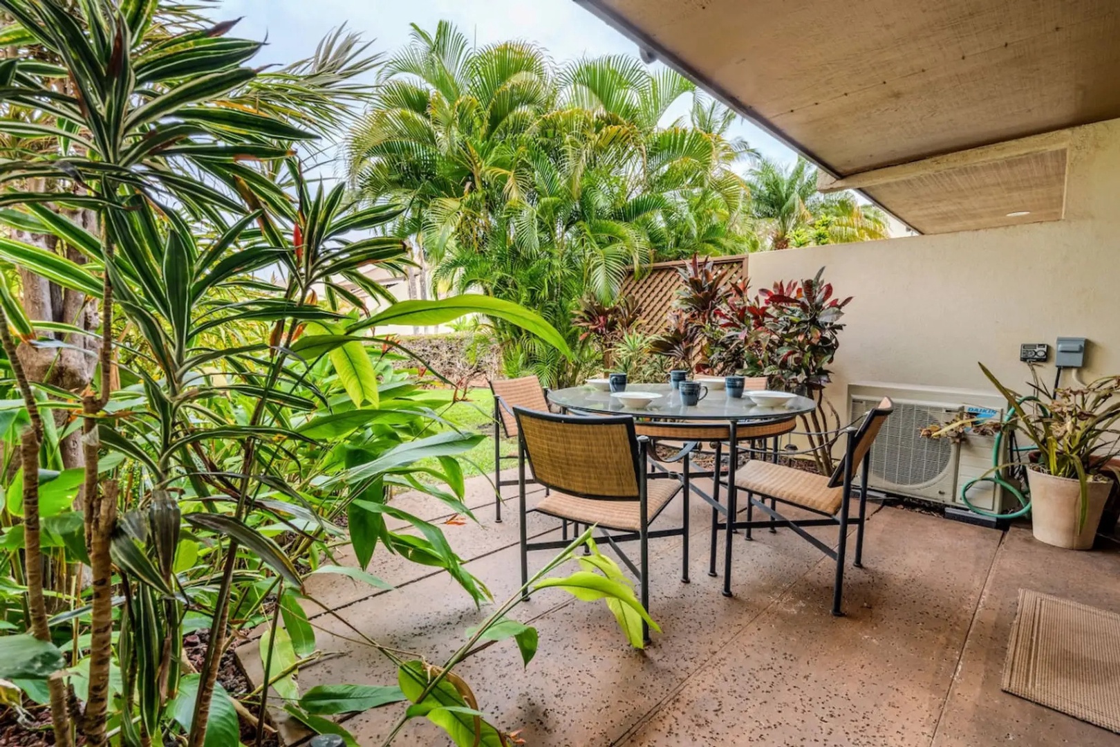 Kihei Vacation Rentals, Maui Kamaole E103 - Green dracaena leaves crowd close around this end of the lanai, private and shaded.