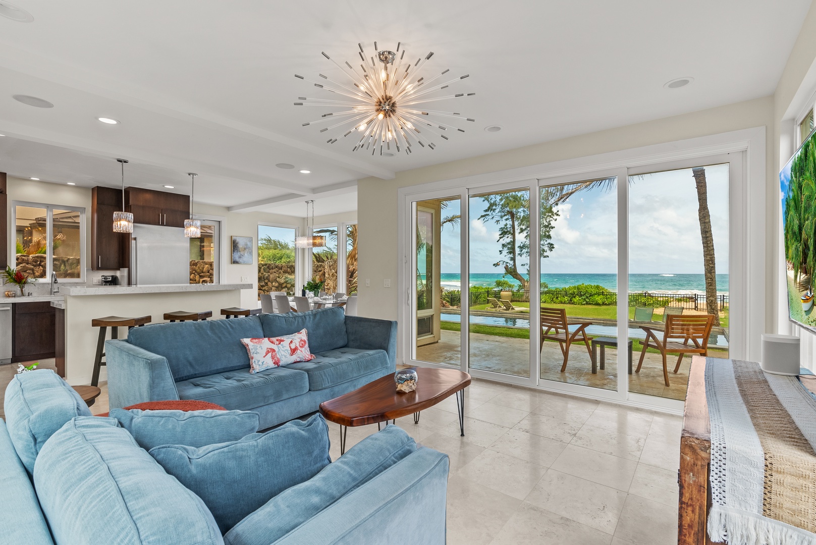 Laie Vacation Rentals, Laie Beachfront Estate - Enjoy the open living area with comfortable seating and large windows showcasing the stunning ocean view.