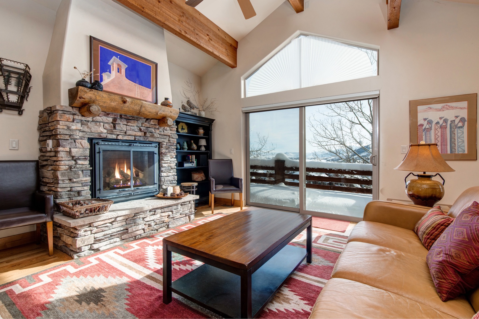 Park City Vacation Rentals, Cedar Ridge Townhouse - Distressed timber beams, vaulted ceilings, and patterned rugs add character to the cozy living space, while a bubbling hot tub awaits on a private deck.
