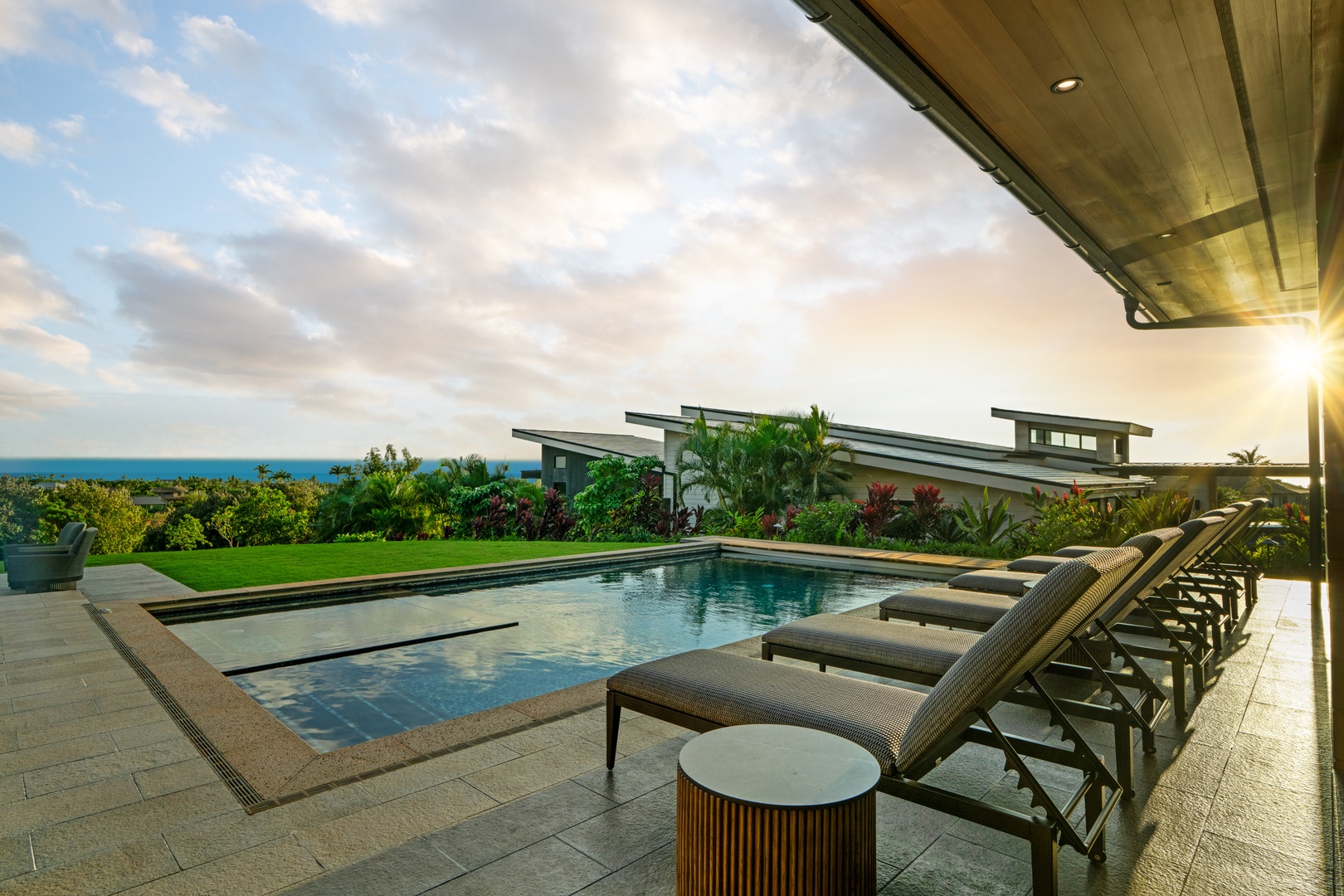 Koloa Vacation Rentals, Hale Laule'a at Kukui'ula - Unwind in your private poolside paradise with stunning ocean views and luxurious loungers perfect for golden hour relaxation.