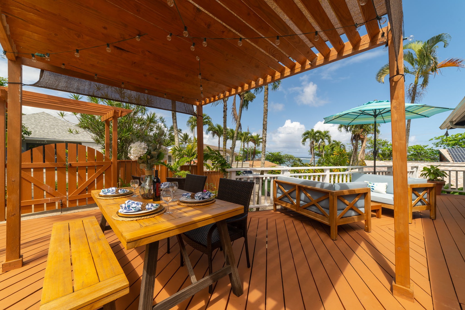 Kaaawa Vacation Rentals, Pali Kai - Outdoor Lanai with Dining Table and Outdoor Sofas to enjoy sunsets, whale watching or soaking in the sun.