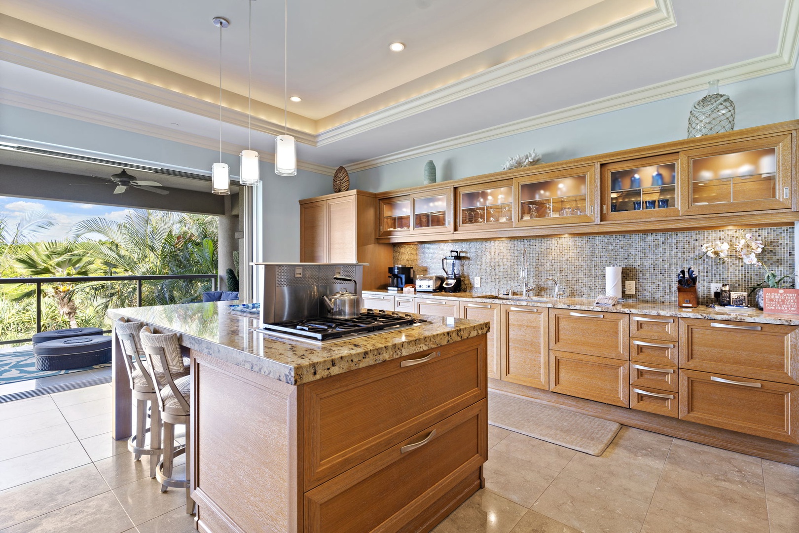 Wailea Vacation Rentals, Wailea Luxury Residence Hoolei 93-3 - Modern kitchen with a large granite island, ample cabinet space, and stainless steel appliances. Ideal for cooking and gathering with views of the lanai.