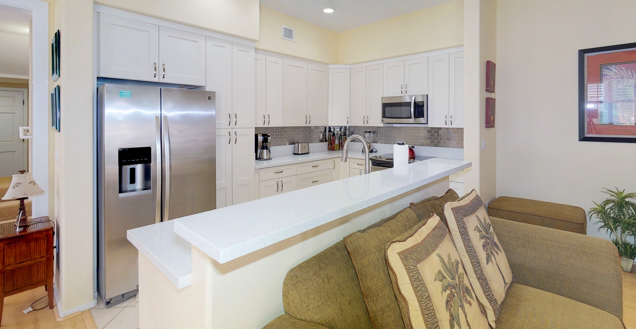 Kapolei Vacation Rentals, Coconut Plantation 1078-3 - The bright kitchen features many amenities including a fridge, oven, extended counter-tops and bright lighting.