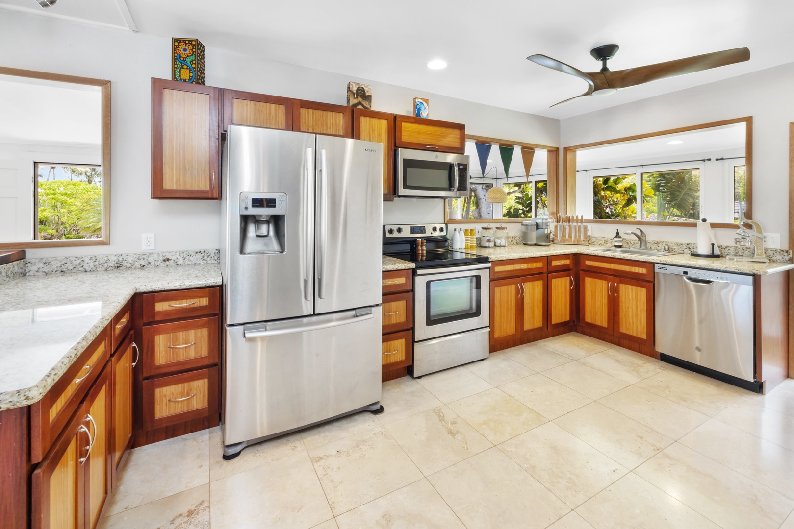 Kahuku Vacation Rentals, Hale Pellicano - The kitchen comes fully equipped with stainless steel appliances and plenty of counter space, ideal for preparing meals with a view of the garden.