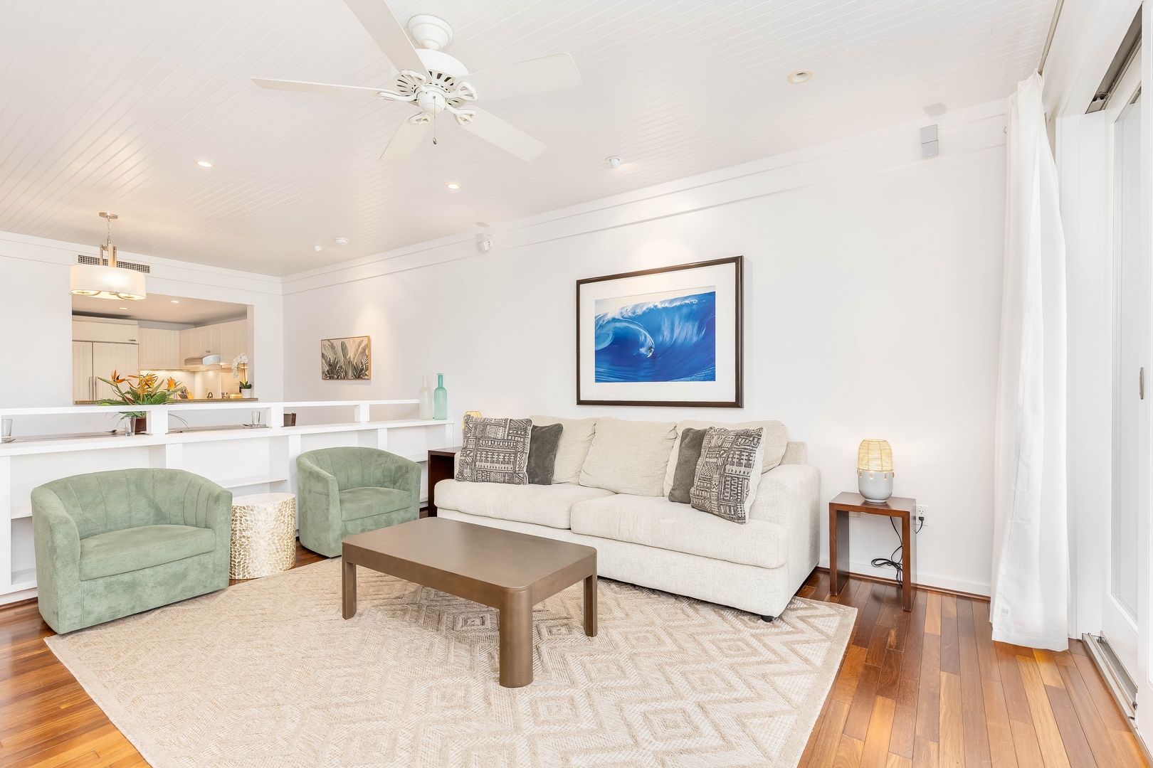 Kahuku Vacation Rentals, Turtle Bay Villas 209 - Sink into plush seating while ocean artwork sets a tranquil mood in your bright, open living space.