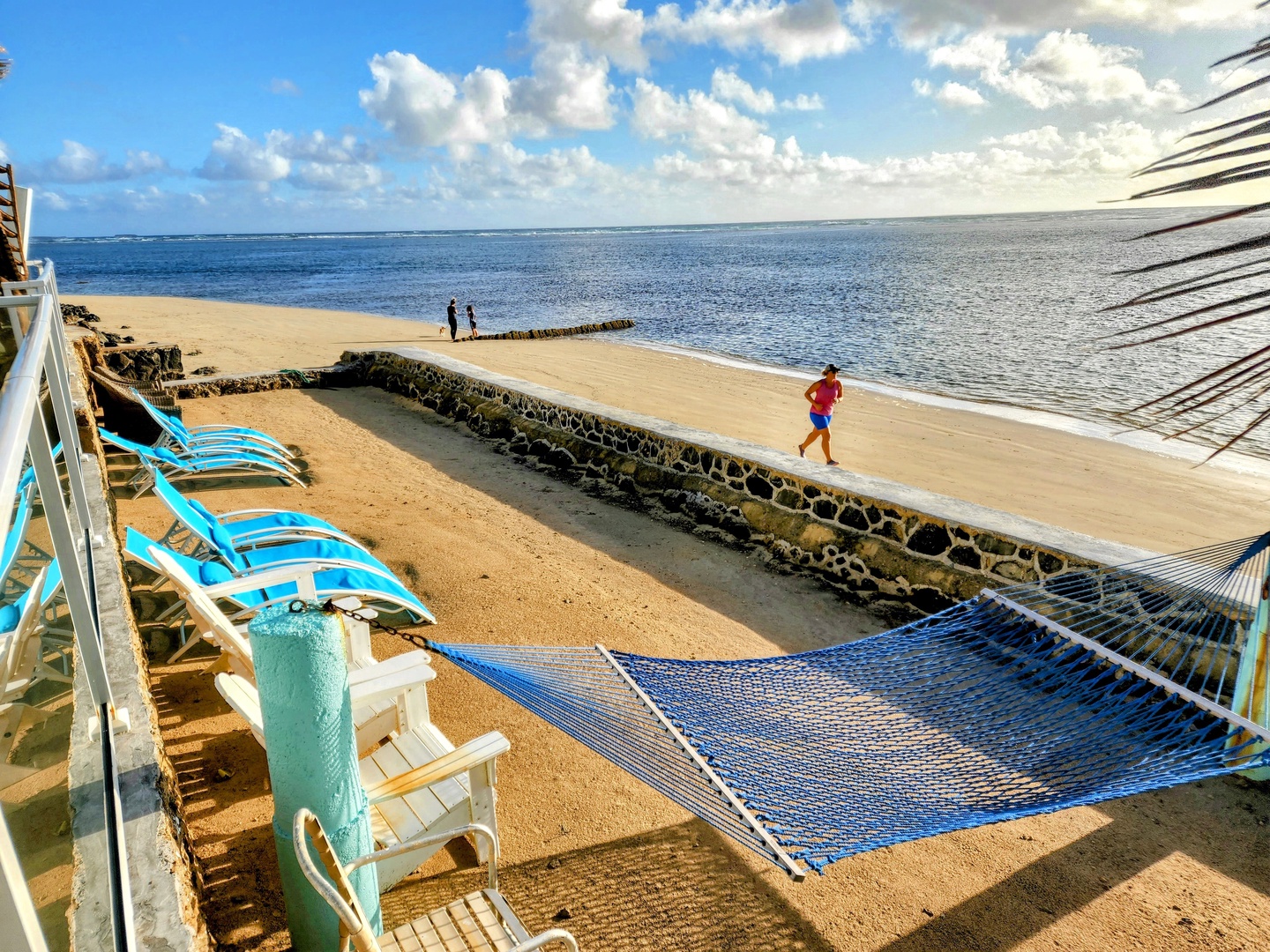 Hauula Vacation Rentals, Private Beach Paradise - A long run of private sand, with chairs and a hammock down its length.