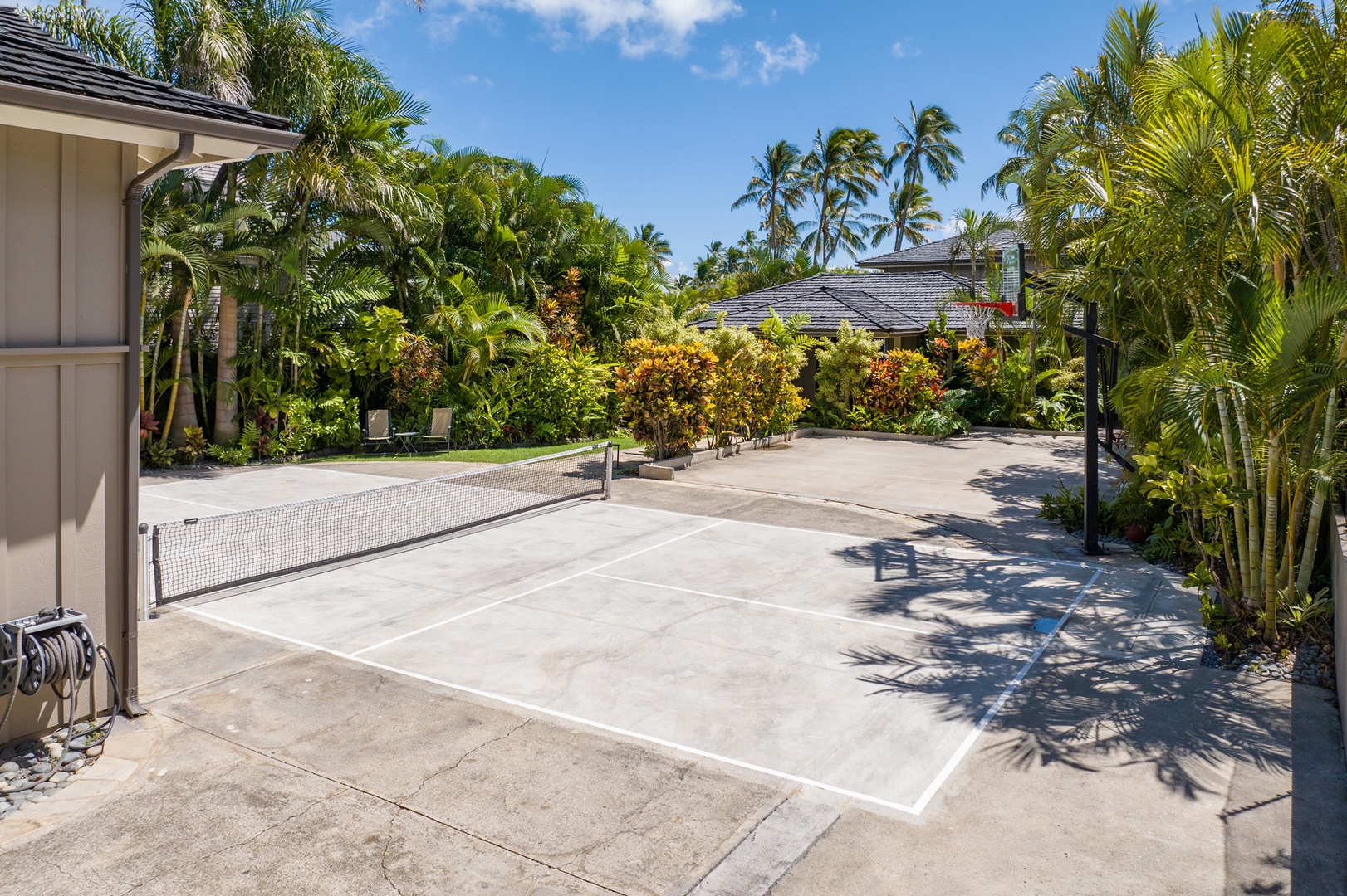 Honolulu Vacation Rentals, Moana Lani - Main House - An open paved court framed by tropical plantings, with room for a pickup game.