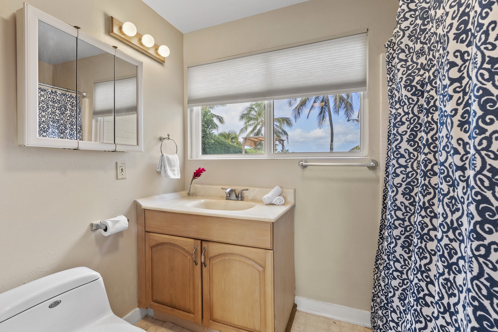 Haleiwa Vacation Rentals, North Shore Beachfront Resort - Ensuite bathroom with a vanity, bright lighting, and walk-in shower.