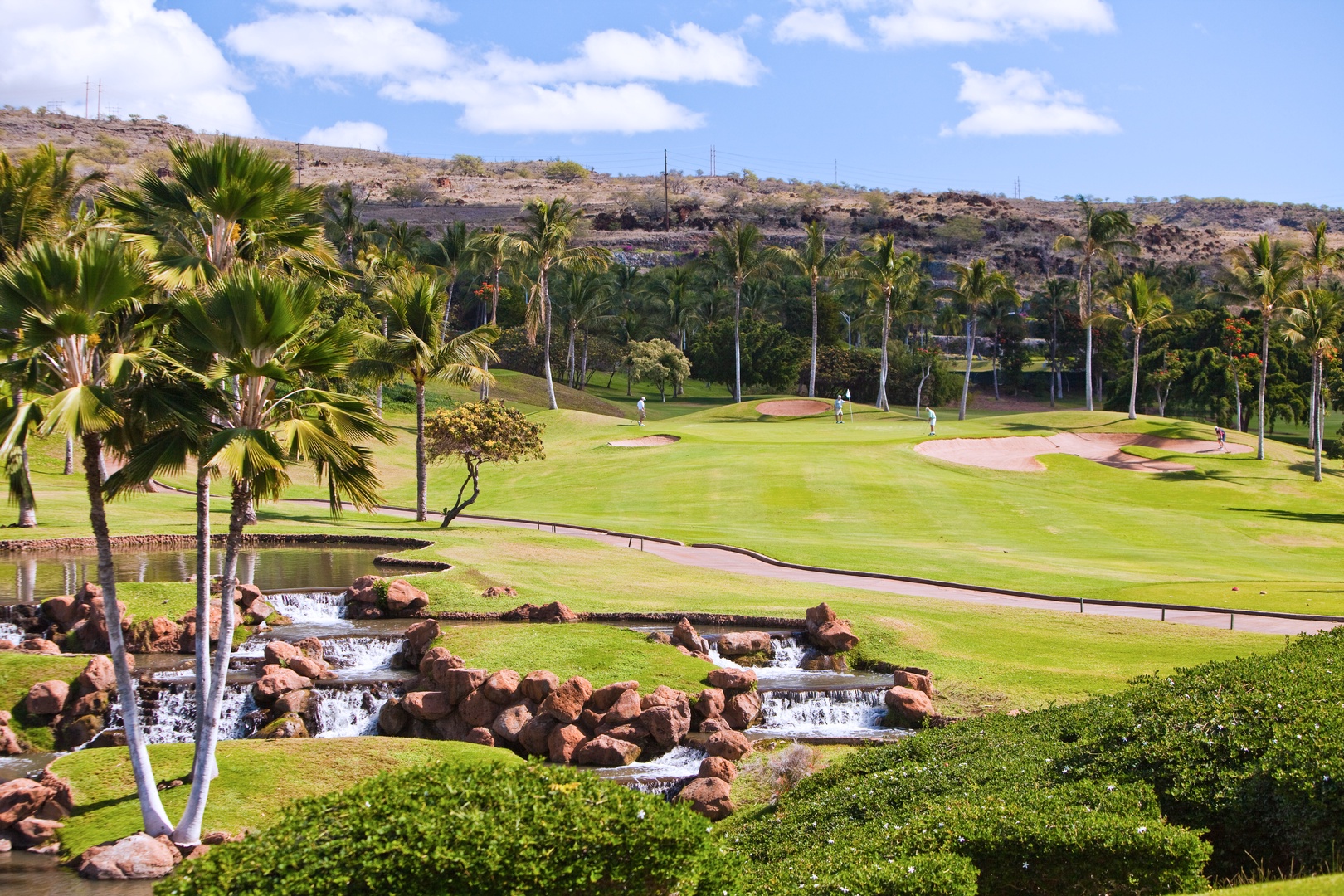 Kapolei Vacation Rentals, Kai Lani 20C - The scenic golf course with lush greenery and cascading waterfalls.
