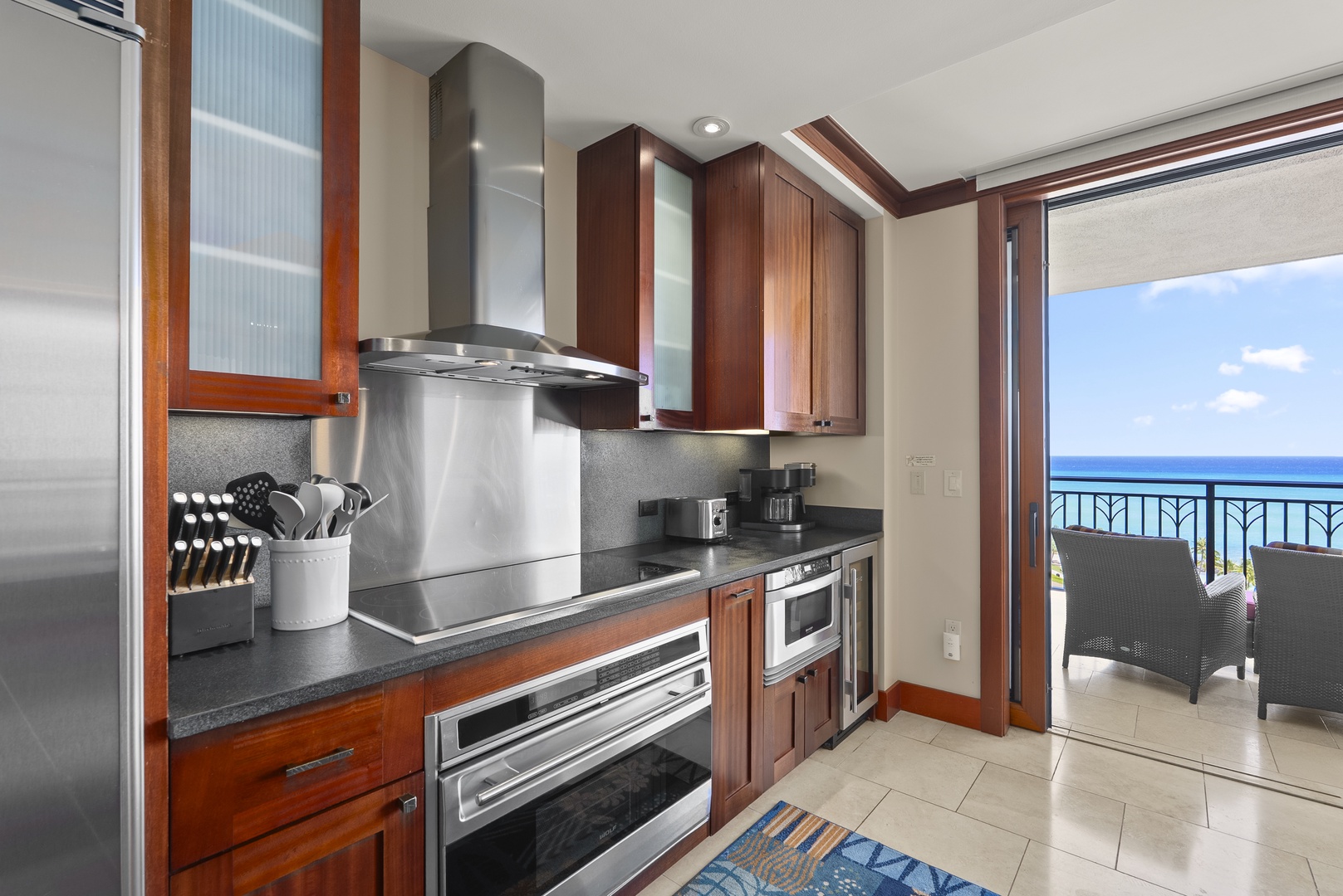 Kapolei Vacation Rentals, Ko Olina Beach Villas O1404 - Pro range under the hood, ocean framed in the window beside it.