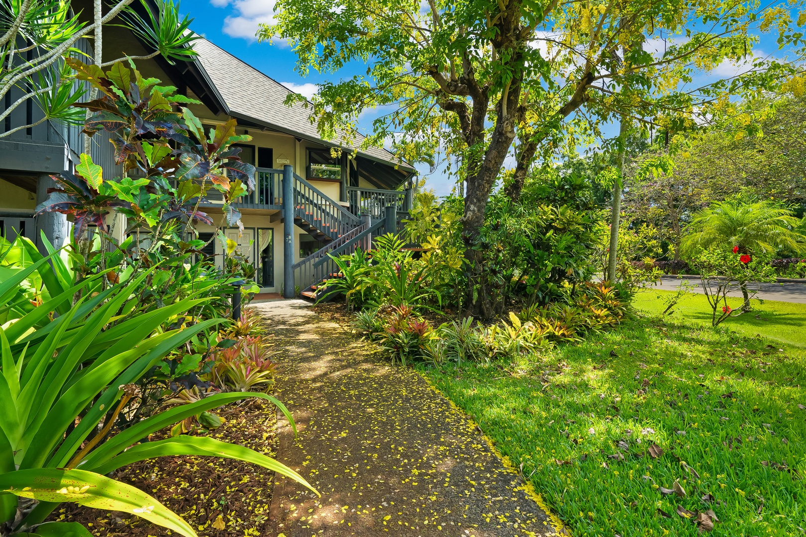 Princeville Vacation Rentals, Mauna Kai 7B - The building tucks into the greenery of the Mauna Kai community.