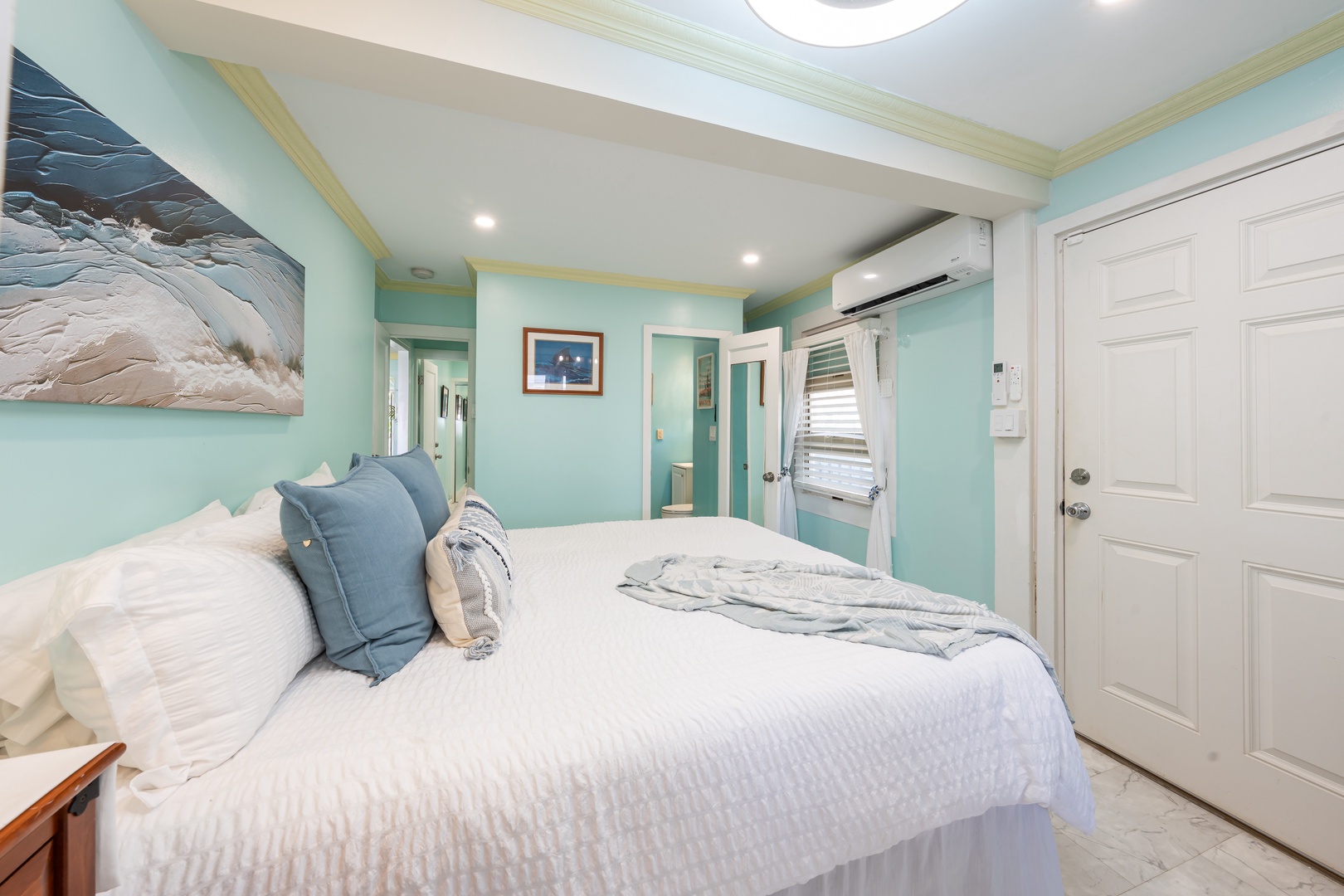 Hauula Vacation Rentals, Private Beach Paradise - Serene coastal bedroom with calming aqua tones and crisp white linens for restful nights.