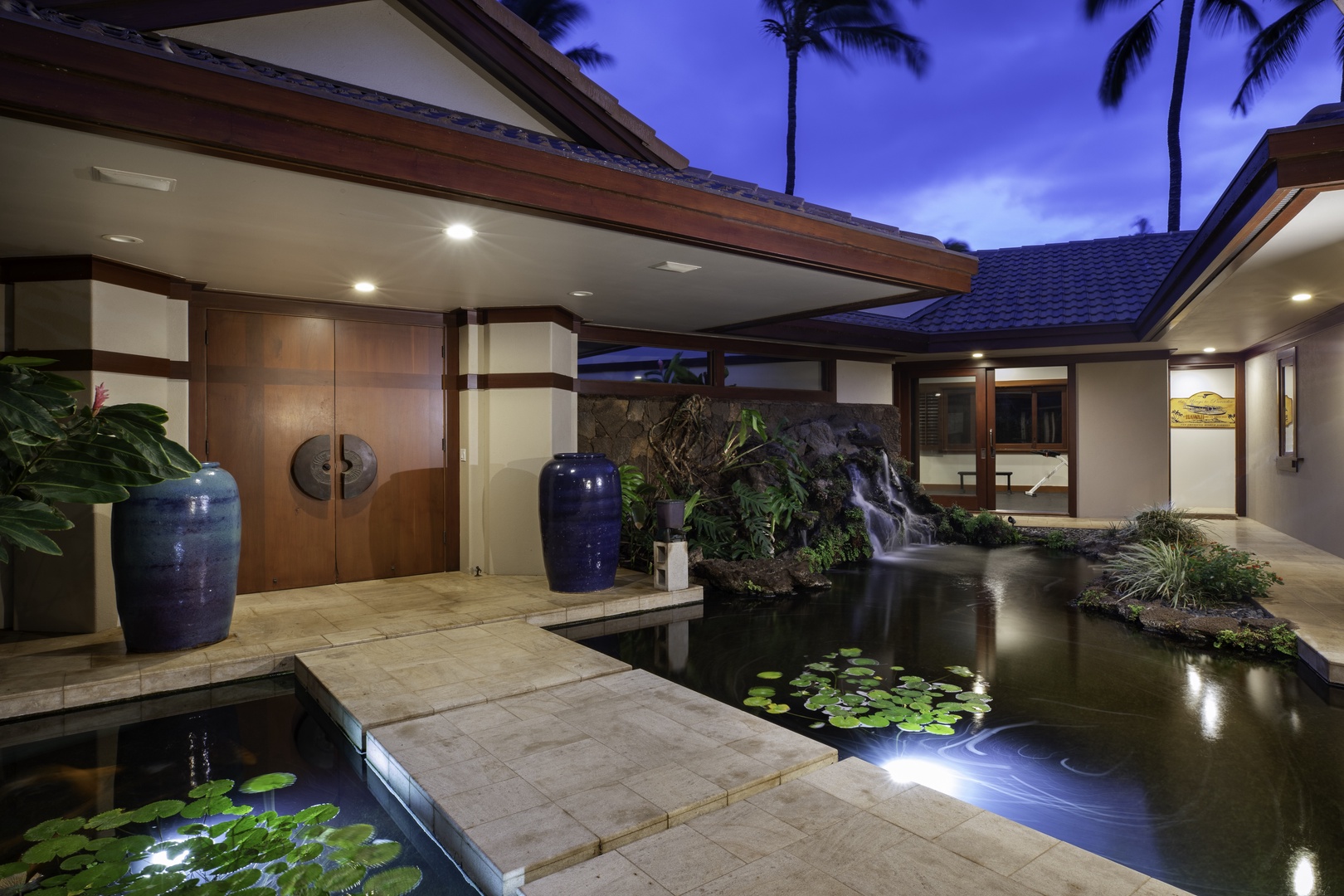 Kamuela Vacation Rentals, Champion Ridge 7 - Elegant courtyard with koi pond and waterfall creates a serene tropical escape under starlit skies.
