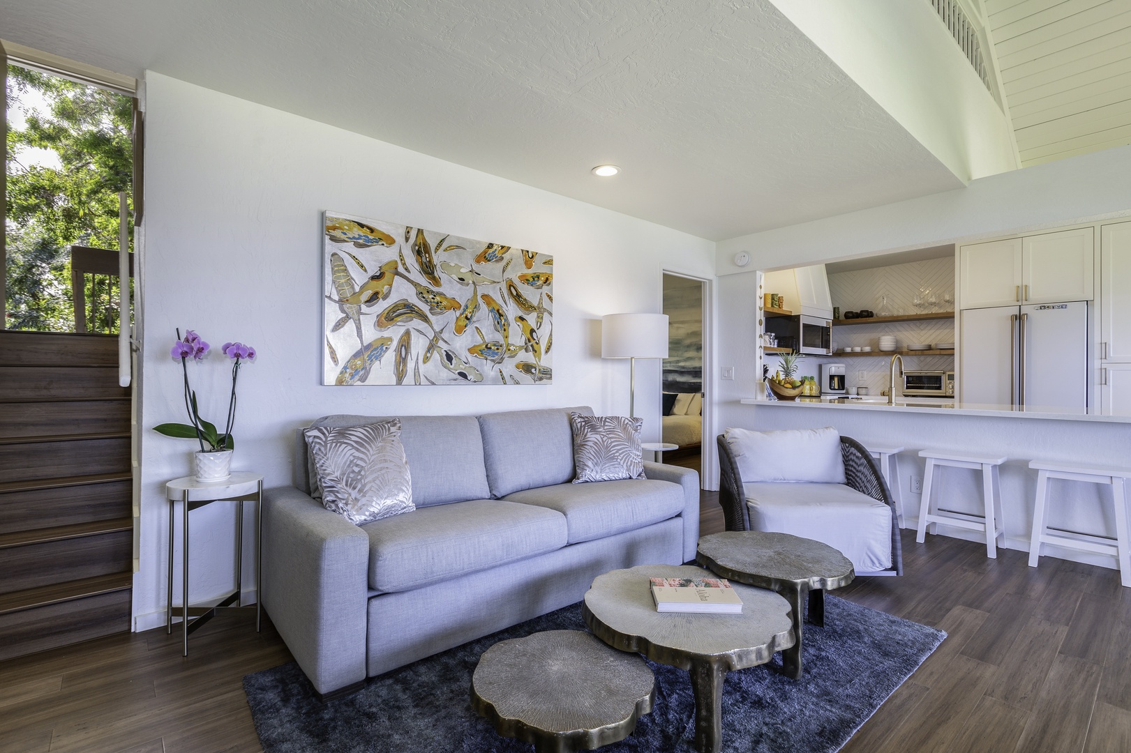 Princeville Vacation Rentals, Pali Ke Kua 207 - Lounging in the living room watching TV or admiring the Hawaiian artwork, this newly renovated split-level unit is sure to have something for everyone! Freshly painted walls, wood floors, and new furniture make this the perfect home aw