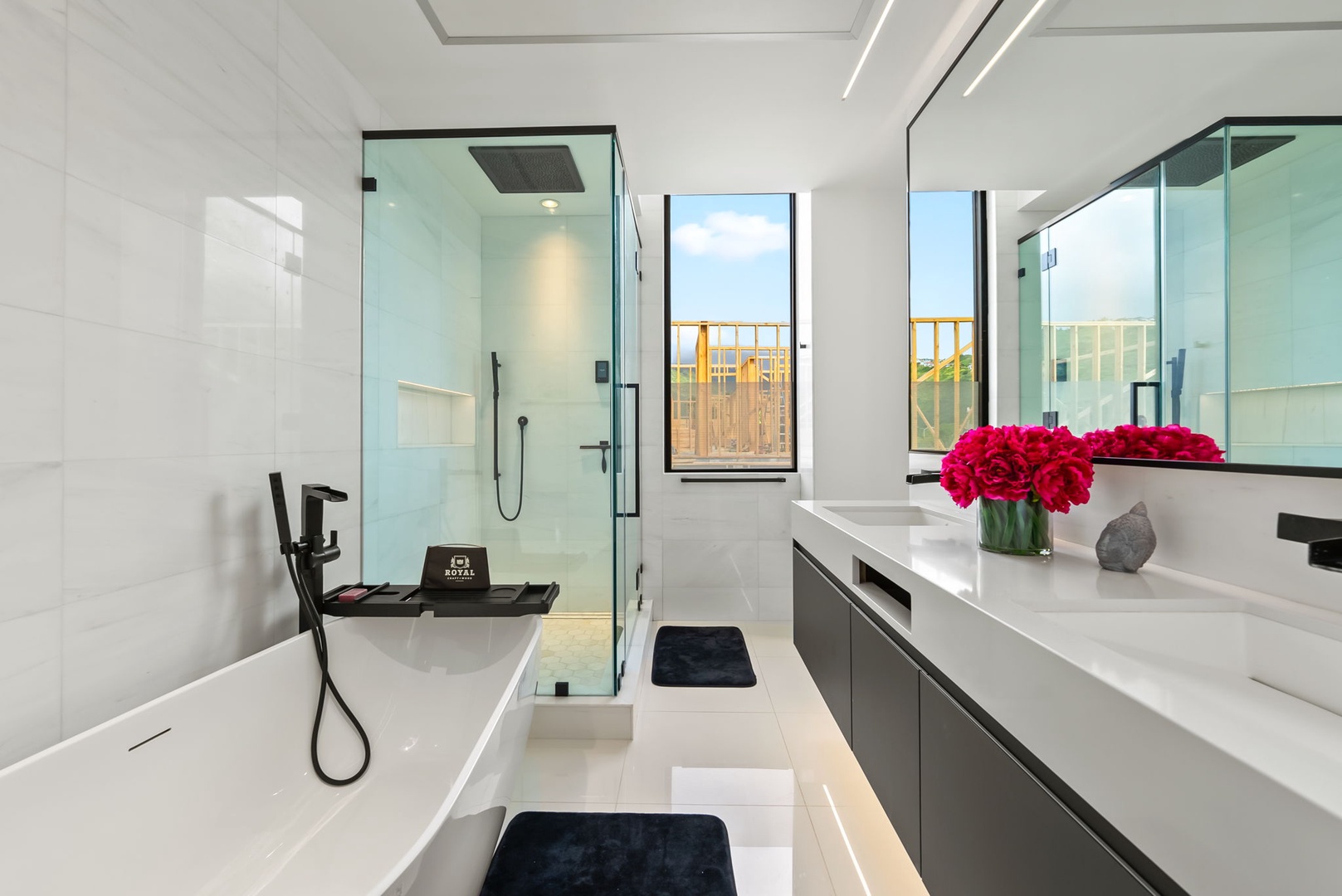 Honolulu Vacation Rentals, Ocean Villa Emilie - This ensuite bath offers a spa-like escape, complete with dual vanities, walk-in shower, and a window that opens to tropical light and breeze.