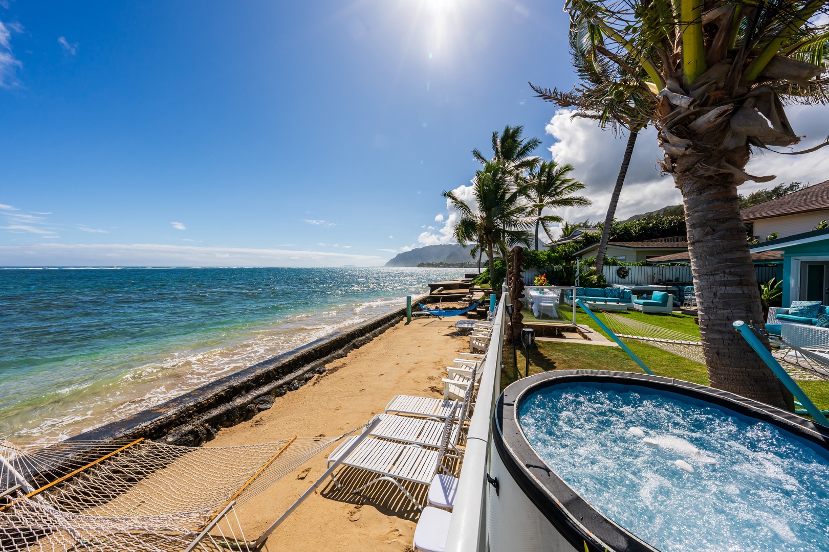 Hauula Vacation Rentals, Private Beach Paradise - Beachfront home with sandy shoreline, ocean views, and tropical landscaping throughout.