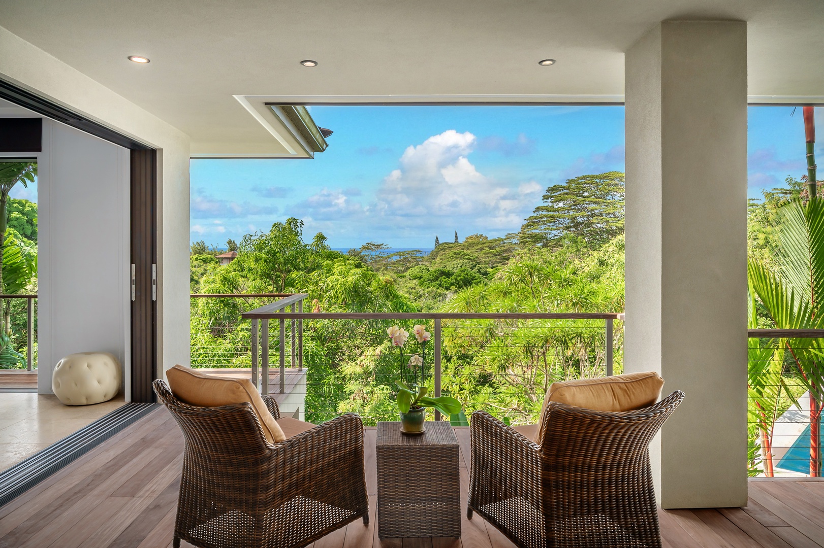 Princeville Vacation Rentals, Hanalei Plantation Villa - Private seating area on the lanai with breathtaking views of the lush landscape, perfect for morning coffee.