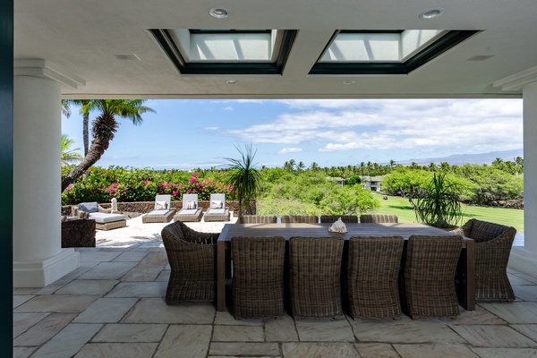 Kamuela Vacation Rentals, Canoe House & Beach Walker at Champion Ridge - Outdoor dining area with wicker seating and beautiful views of the landscape.