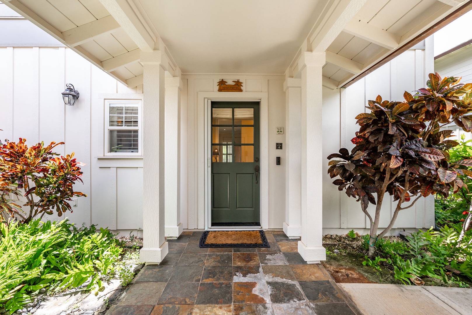 Kapolei Vacation Rentals, Coconut Plantation 1080-4 - Come in through the green door off a walkway framed with tropical plants.