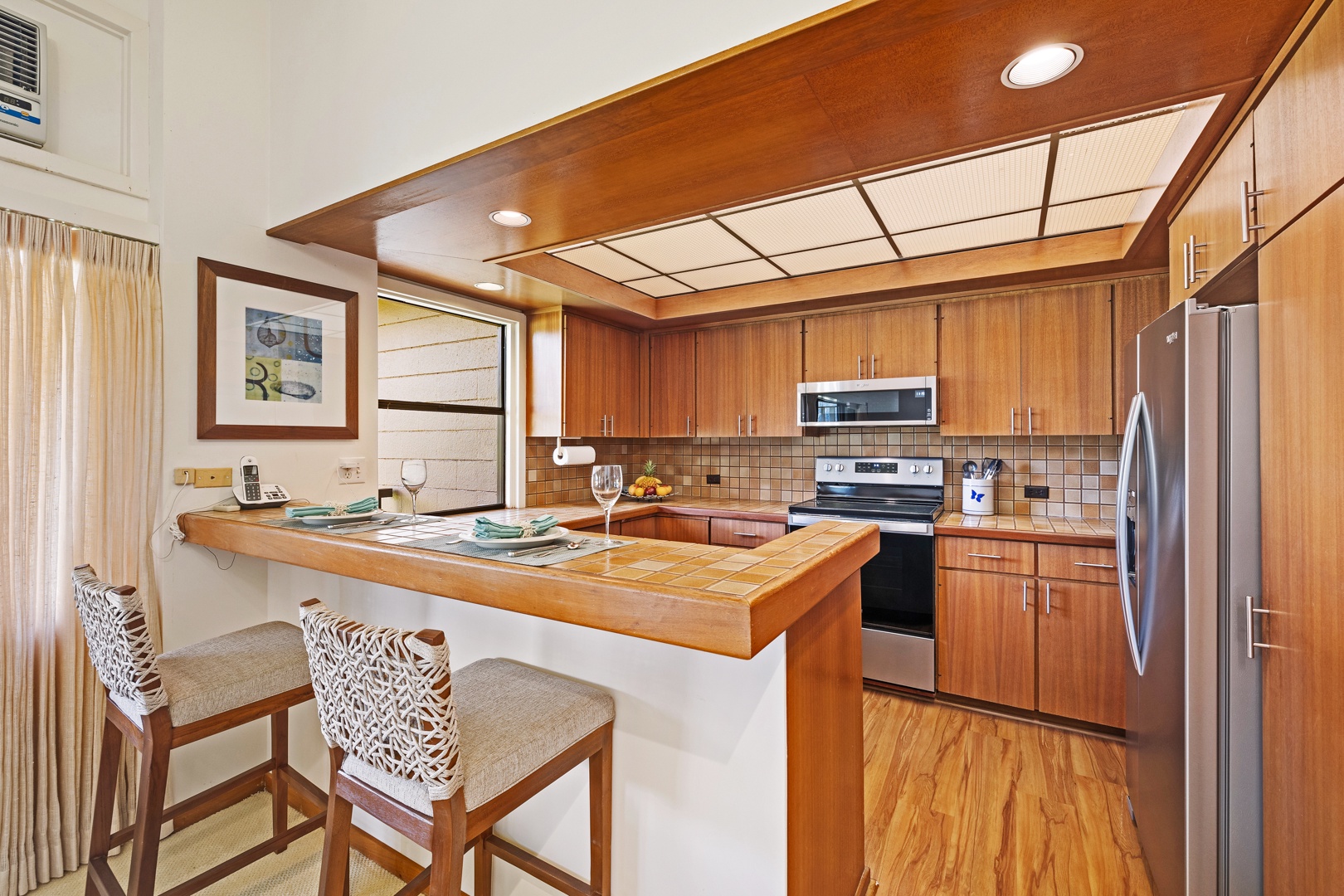 Lahaina Vacation Rentals, Kapalua Ridge 2321 - Kapalua Ridge 2321’s kitchen features sleek appliances and a cozy bar for casual dining or evening drinks.