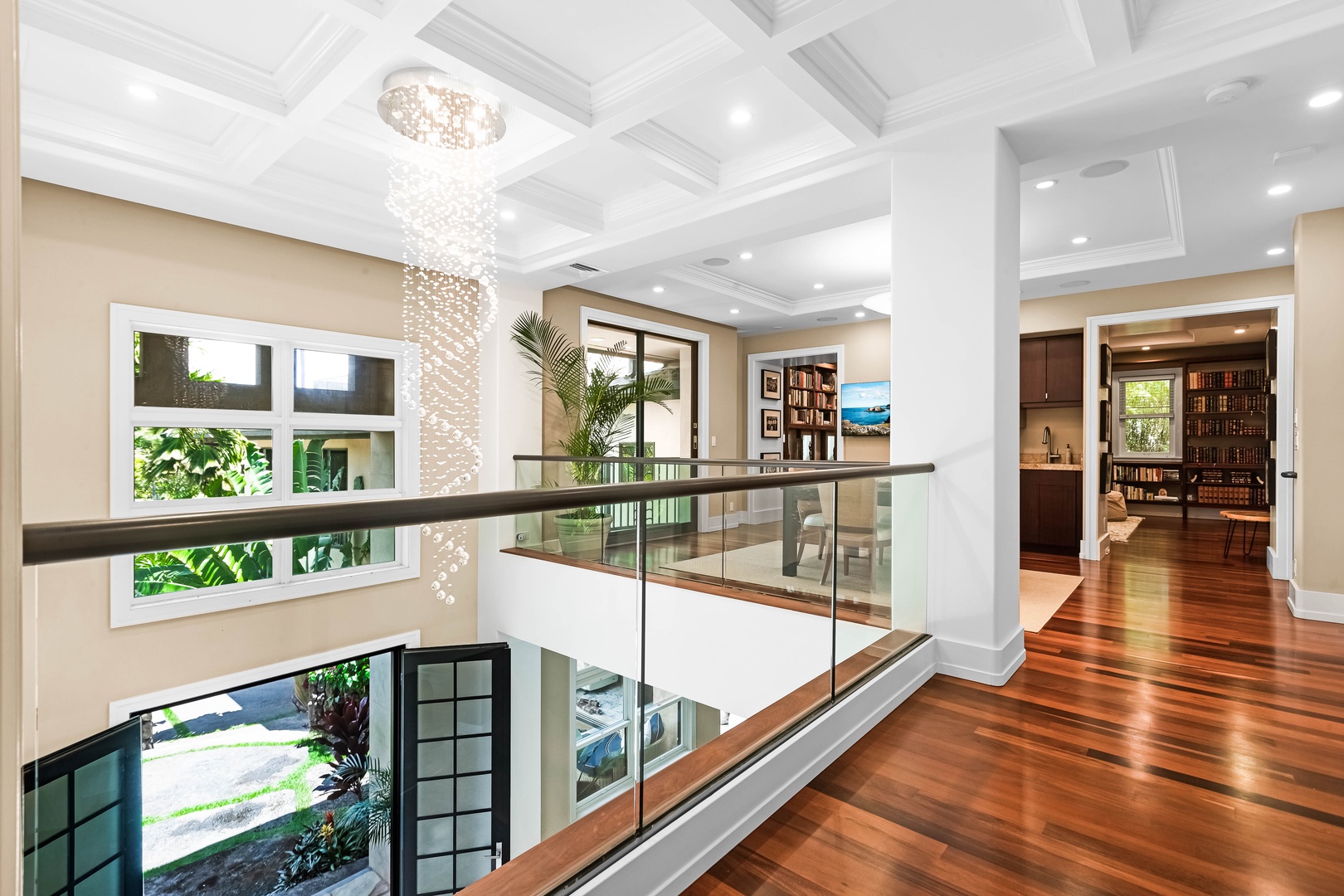 Honolulu Vacation Rentals, Pili Pono - Upper-level landing with glass railing and chandelier lighting.