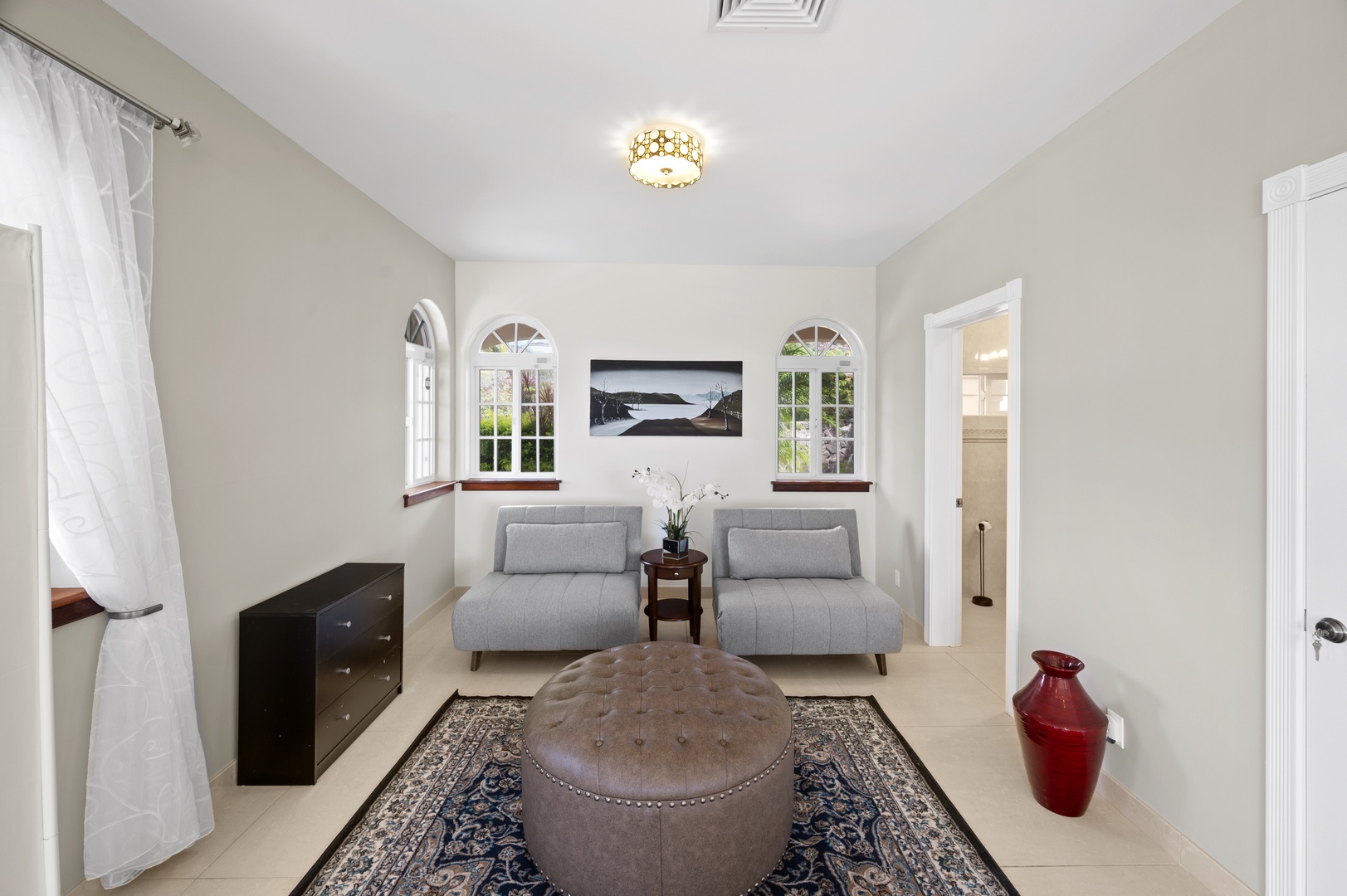 Honolulu Vacation Rentals, Lotus on a Hill* - The downstairs family room easily converts to a 5th bedroom using a room divider and is equipped with a full bath & walk-in closet. The two sofa chairs fold out to become twin size beds.