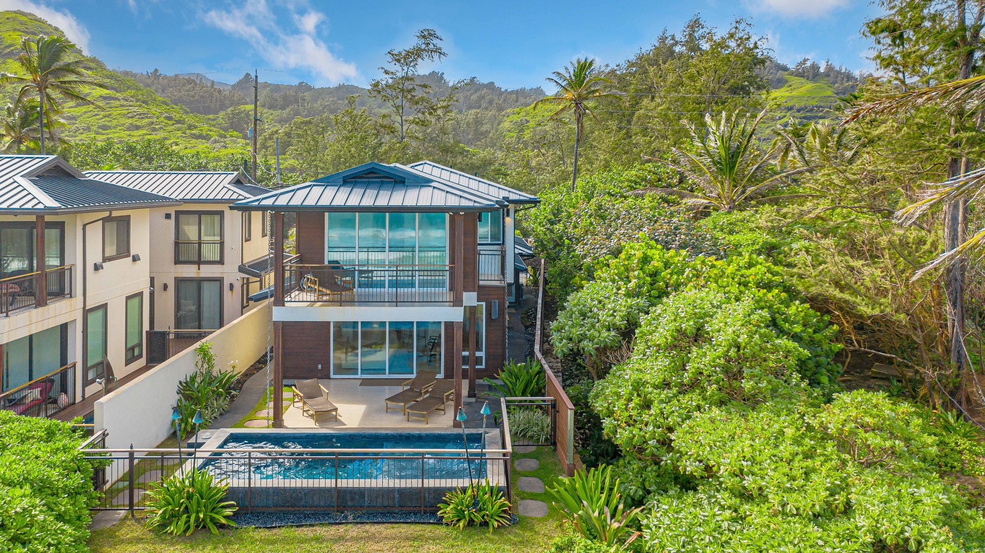 Laie Vacation Rentals, Majestic Mahakea Oceanfront Oasis - Luxury living with a private pool, surrounded by verdant greenery and ocean vistas.