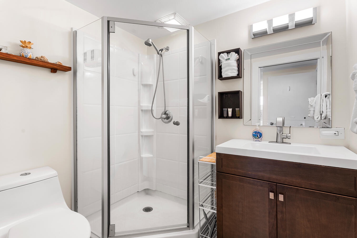 Kailua Kona Vacation Rentals, Kona Plaza 201 - Step into your pristinely renovated bathroom featuring a spacious walk-in shower, modern vanity, and thoughtfully placed amenities for your comfort.
