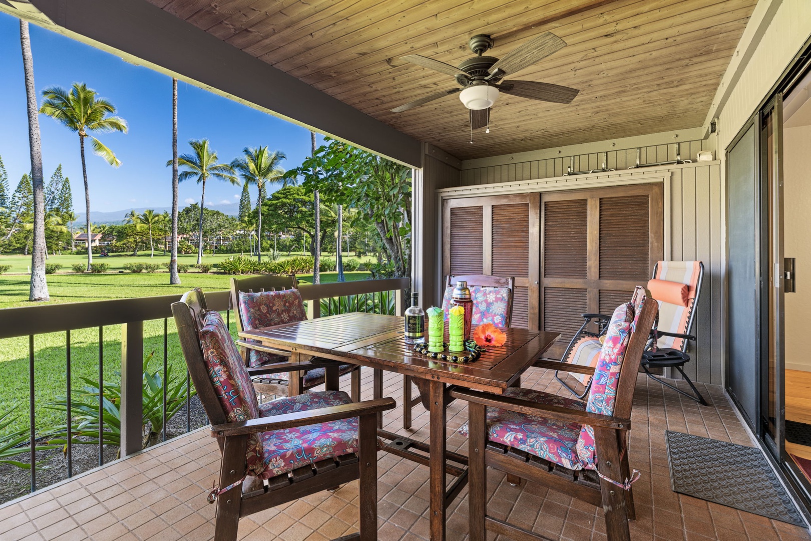 Kailua Kona Vacation Rentals, Kanaloa at Kona 701 - Sip your drink of choice on this charming lanai with golf course views and gentle trade winds cooling your private retreat.