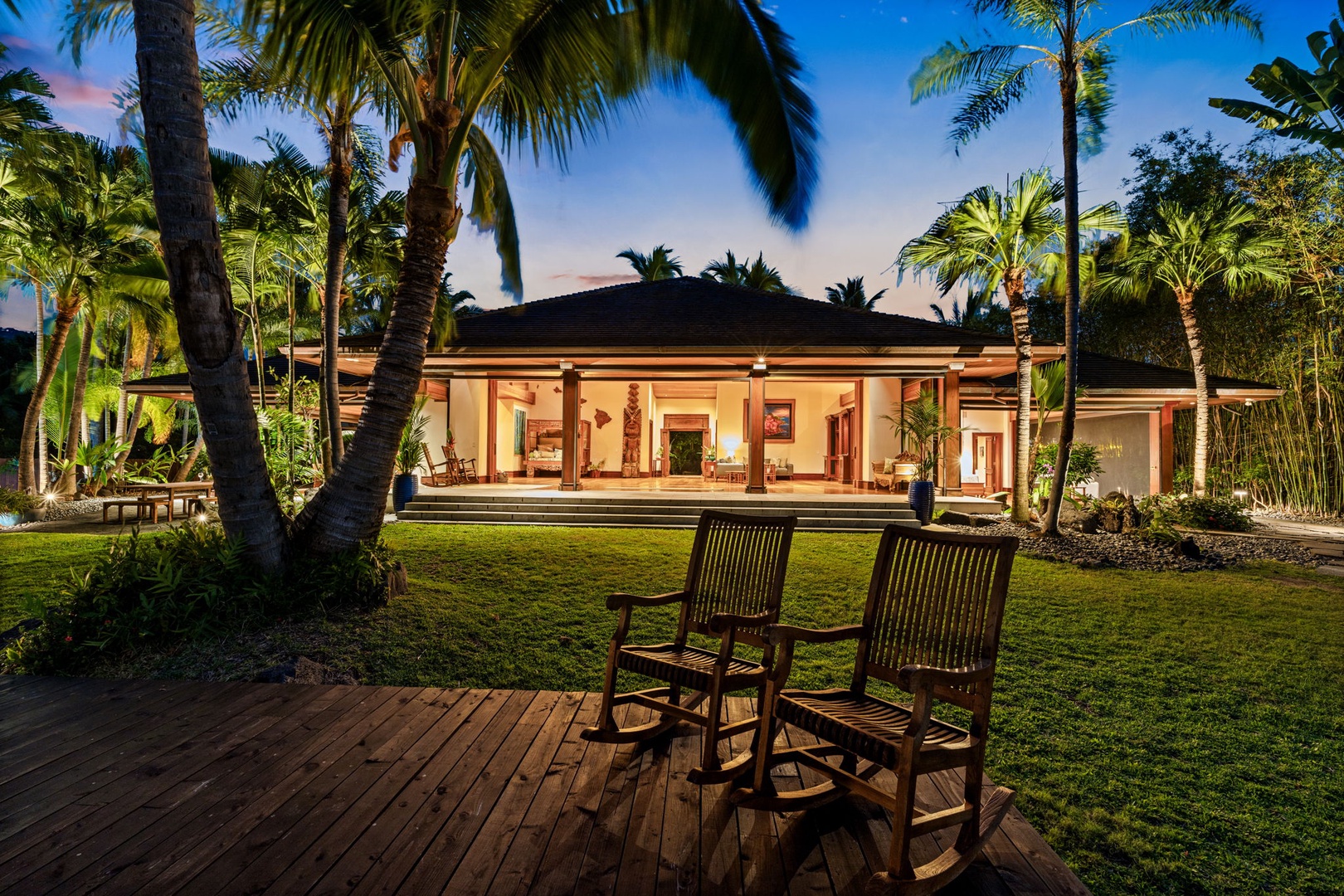 Kailua-Kona Vacation Rentals, Hahalua Bay Villa - Stunning tropical villa surrounded by swaying palms and manicured gardens, illuminated beautifully at dusk.