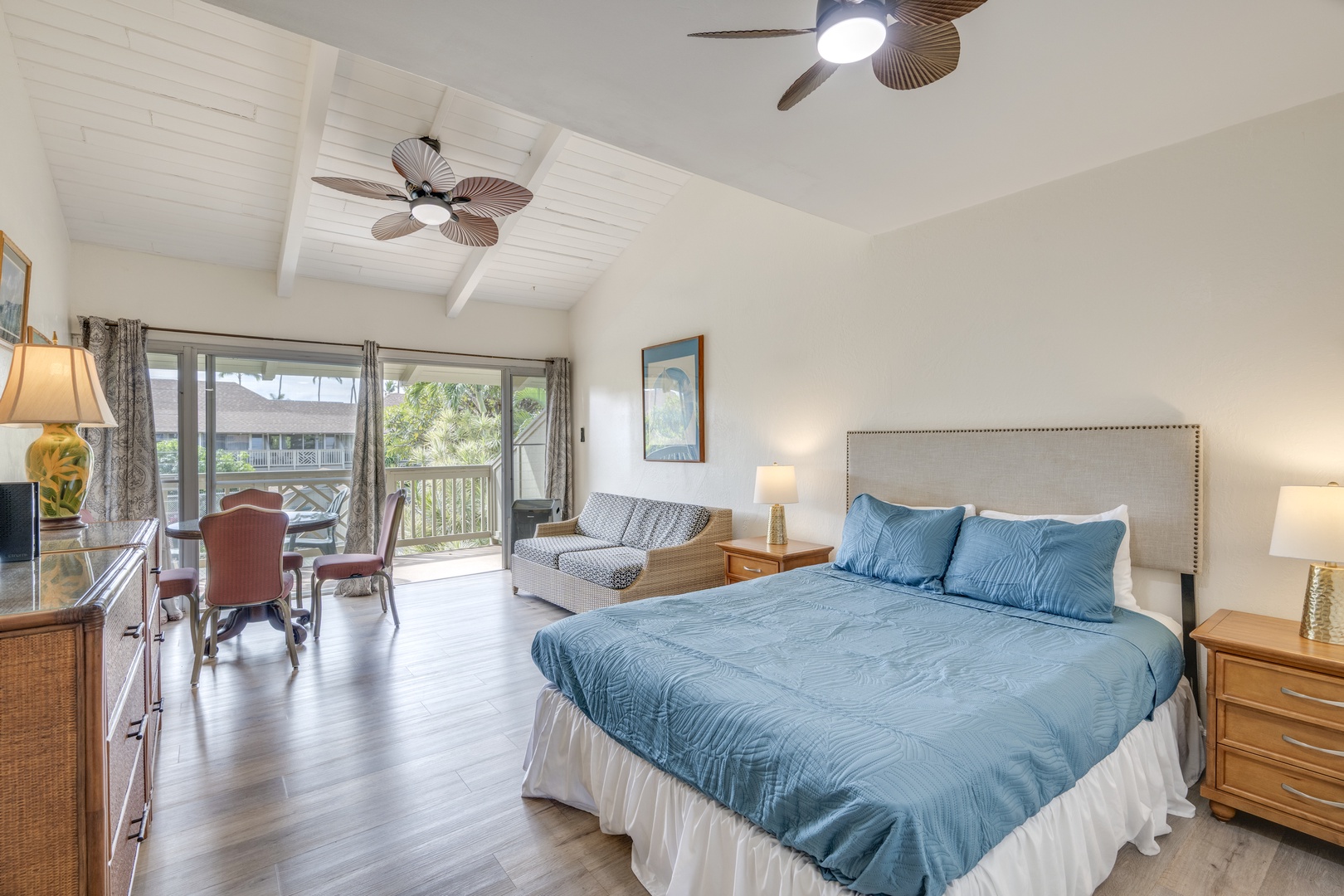 Kihei Vacation Rentals, Kihei Bay Surf B212 - Spacious suite with tropical ceiling fans, cozy seating area, and lanai overlooking lush greenery—your perfect island retreat awaits.
