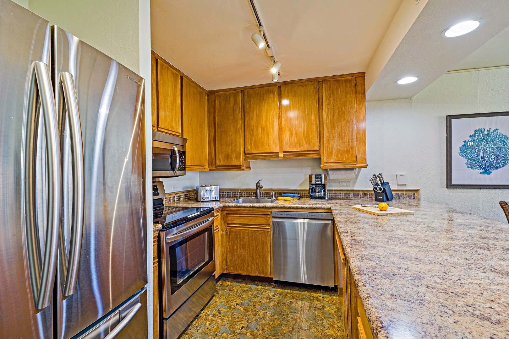 Lahaina Vacation Rentals, Kaanapali Shores 544 - The kitchen features modern appliances and ample counter space, making it perfect for preparing meals or enjoying a quick snack with family and friends.