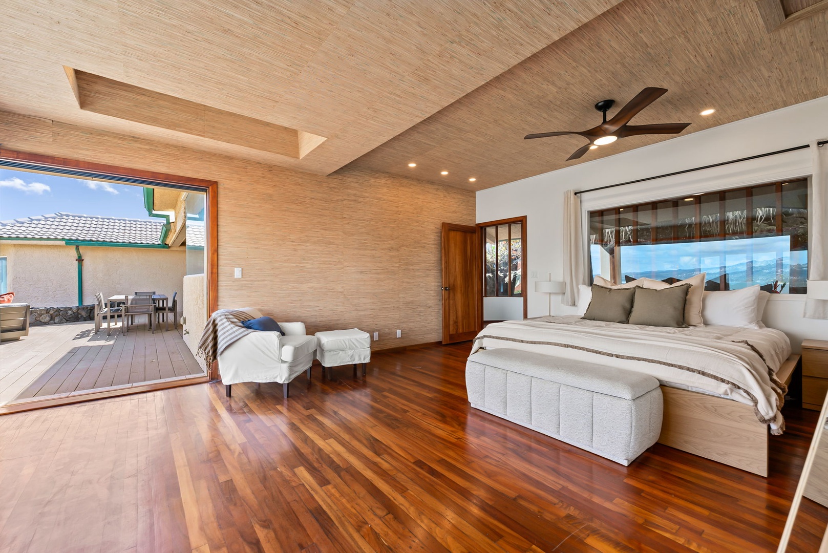 Honolulu Vacation Rentals, Black Point Ocean Villa - Relax in this spacious bedroom with stunning ocean views, warm wood accents, and private lanai access for ultimate tranquility.