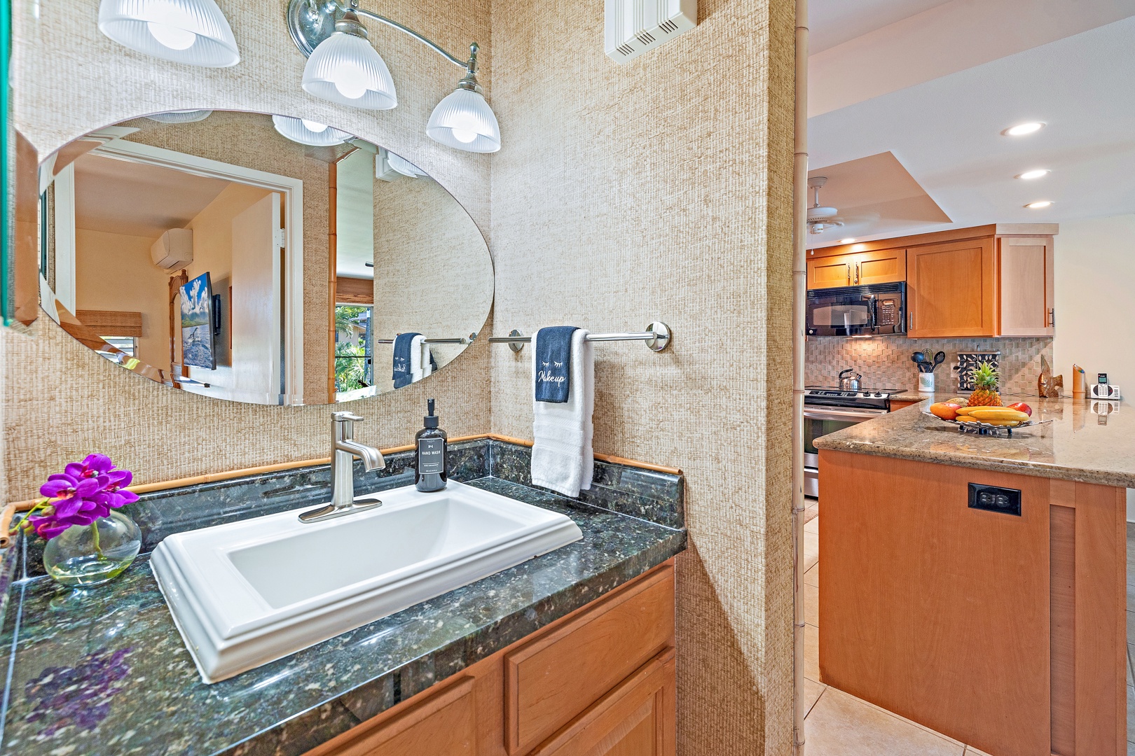 Lahaina Vacation Rentals, Kahana Sunset B4B - The bathroom includes a stylish granite vanity, a modern sink, and bright lighting, offering a comfortable and elegant space to get ready for your day.