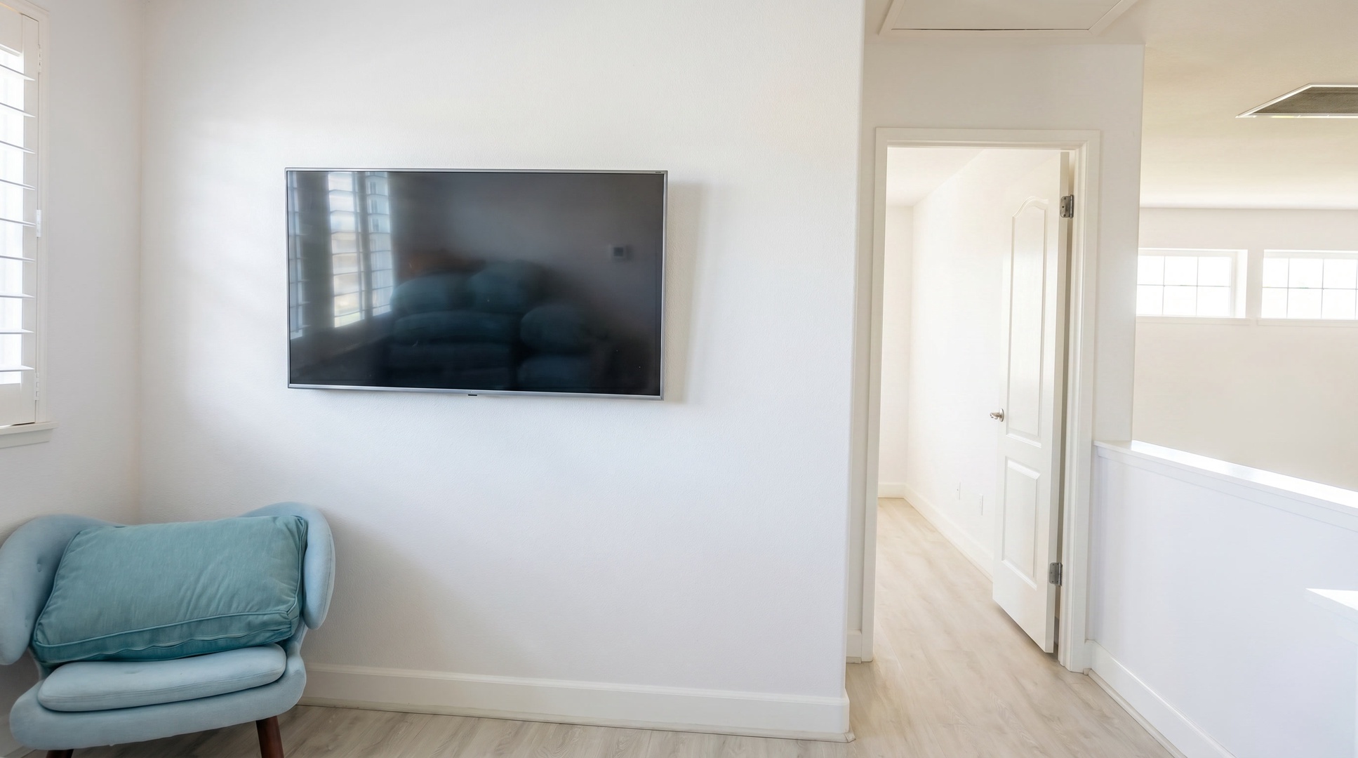 Catch a game on the wall-mounted TV from the armchair in the corner.