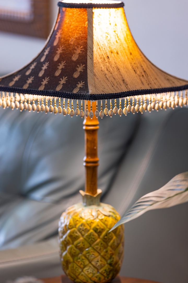 Kapolei Vacation Rentals, Ko Olina Kai 1105E - A charming pineapple-motif lamp with a fringed shade adds a playful tropical touch to your cozy living space, casting a warm, inviting glow.