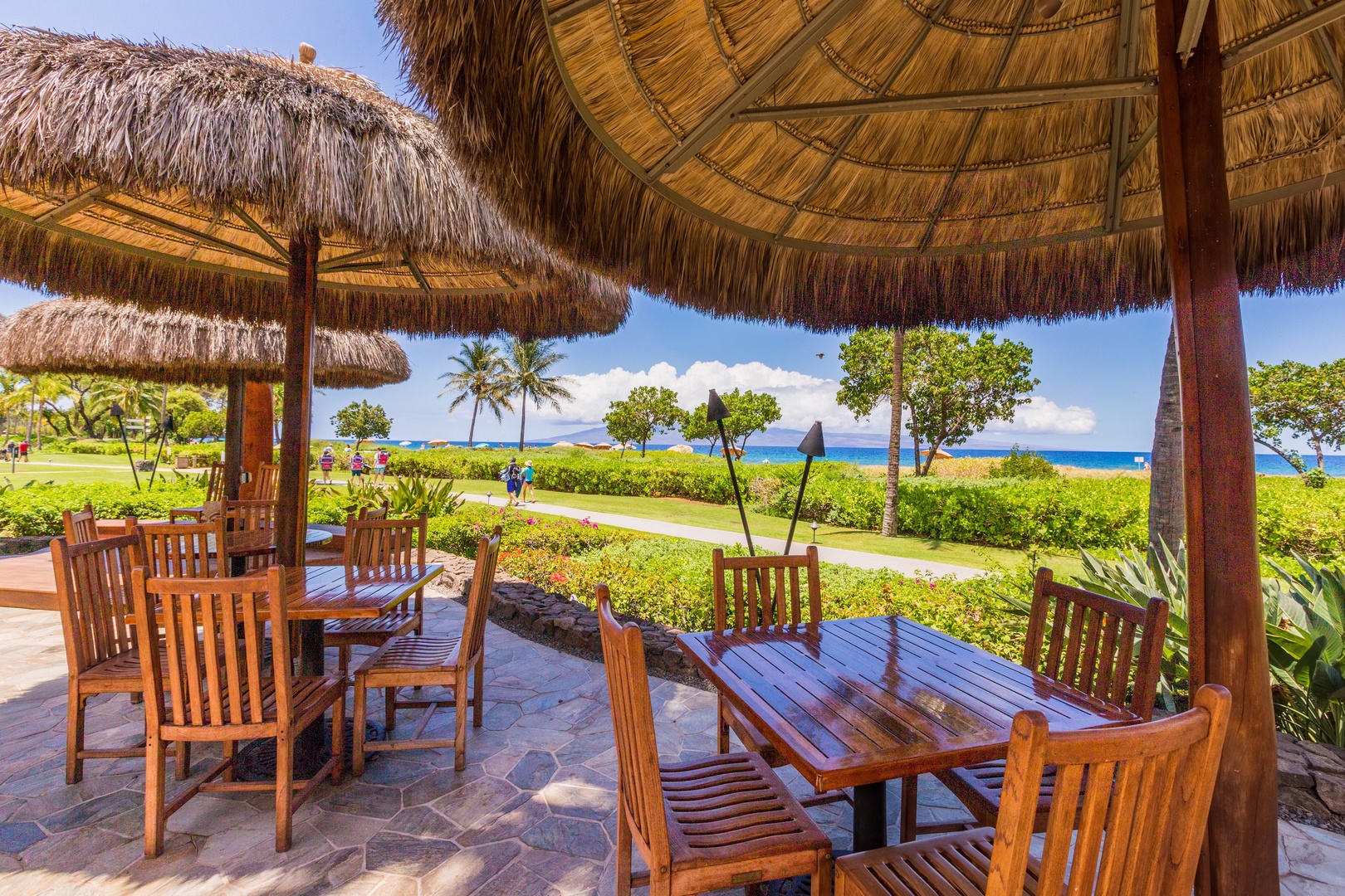 Lahaina Vacation Rentals, Honua Kai Hokulani 214 - Enjoy outdoor dining under the shade of traditional thatched umbrellas with stunning ocean views.