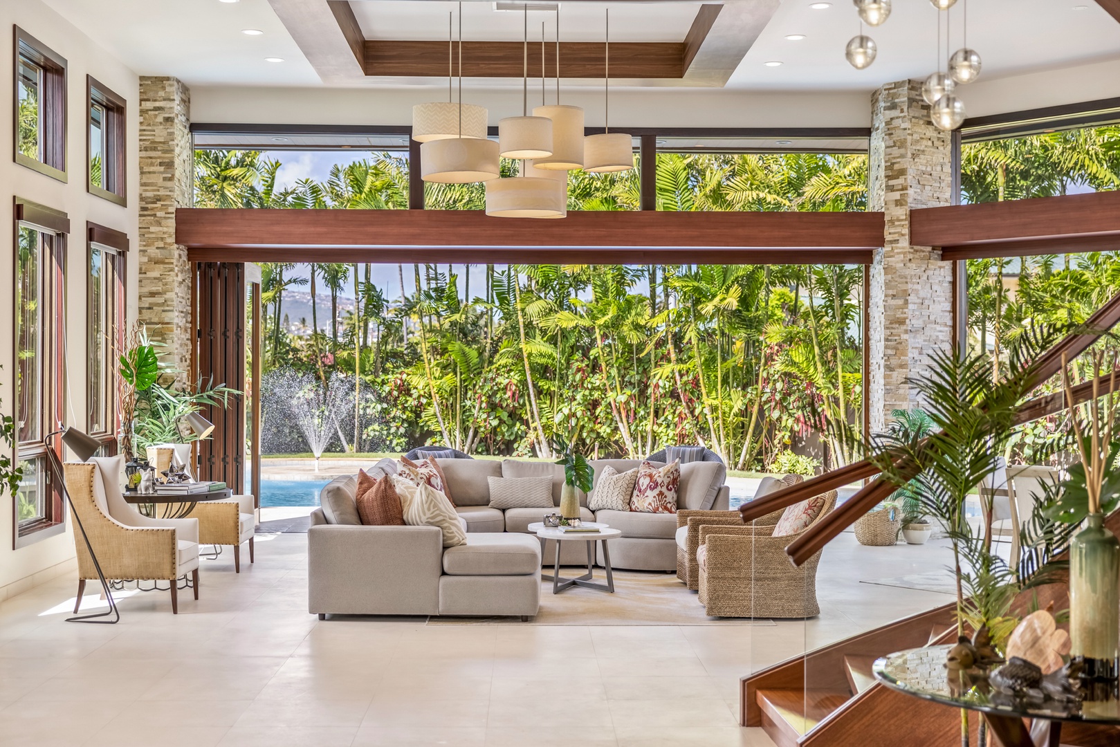 Honolulu Vacation Rentals, Kahala Grand Splendor - Unwind in the open-concept living room with plush seating and lush tropical views.