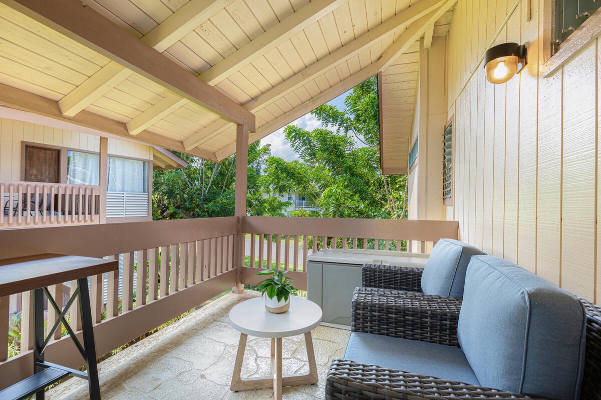 Princeville Vacation Rentals, Hale Ohana Ho'omaka - Cozy covered lanai with seating. A tranquil spot to unwind and enjoy the island breeze.