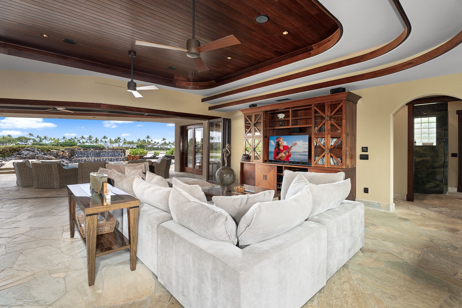 Kamuela Vacation Rentals, Hale Konane - Unwind in the inviting living area with plush seating and a rich wood-paneled ceiling.
