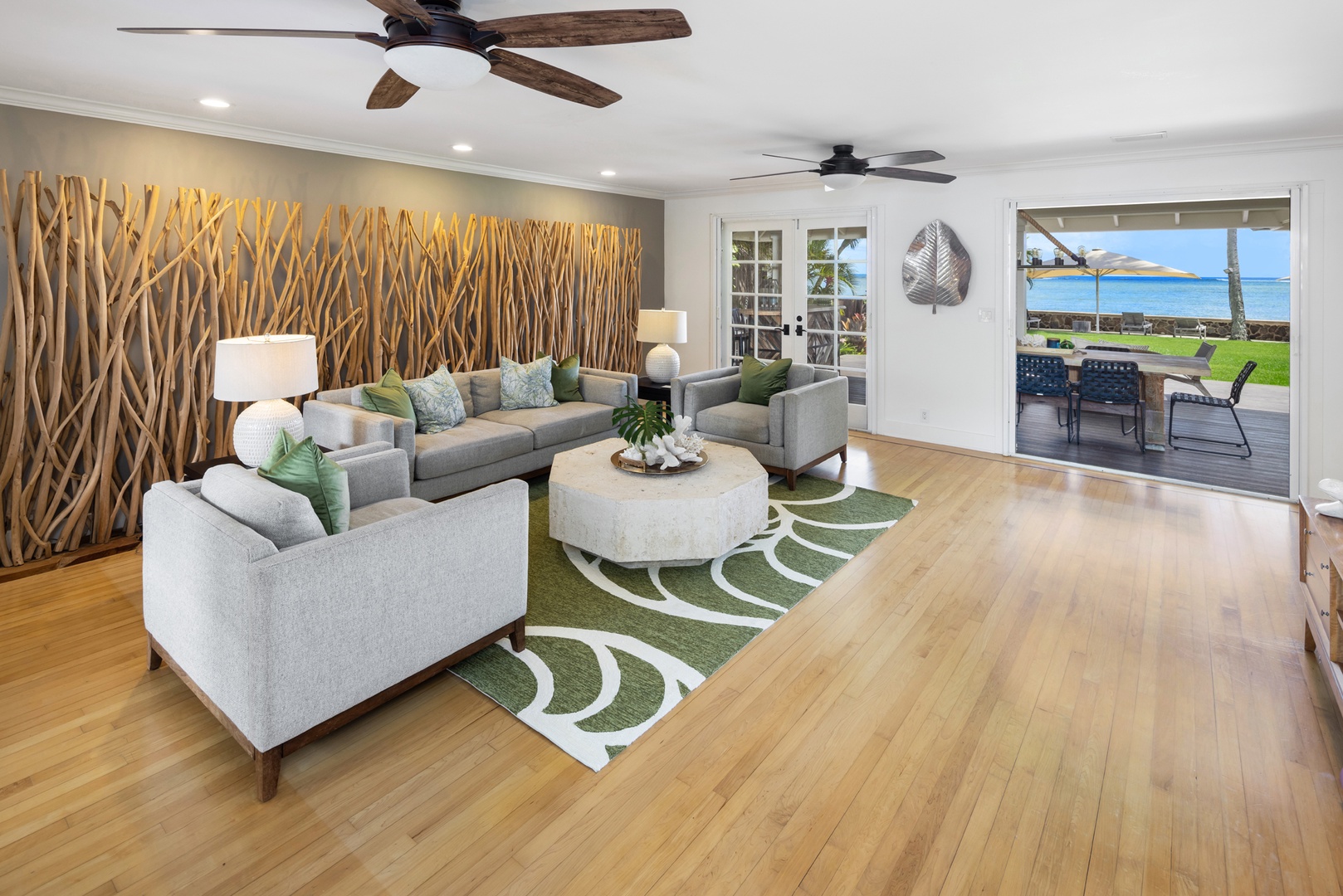 Honolulu Vacation Rentals, Moana Lani - Main House - Gather on the white sofas against the driftwood wall, with the ocean just past the glass doors.